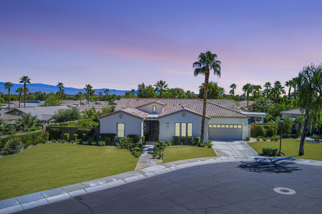 Experience the pinnacle of desert living in this rare Tamarisk model with detached casita, ideally situated on a private cul-de-sac within Trilogy La Quinta. Set on an expansive .35-acre homesite, this exceptional residence offers a beautifully landscaped front lawn, an inviting courtyard with ornate entry gate, three covered patios, an outdoor fireplace, and a resort-style pool and spa highlighted by a dramatic stone waterfall. Encompassing approximately 2,726 sq. ft. of refined single-level living, the home showcases 4 bedrooms, 4 bathrooms, a formal dining room with bay window, and a spacious great room with custom media niche. Recent upgrades include fresh interior and exterior paint (including the casita), new porcelain tile flooring with 7-inch baseboards, shutters, shades, and a custom-designed TV and electric fireplace wall. The gourmet kitchen is a true showpiece, boasting all-new cabinetry, quartz Gucci stone island, stainless steel sink, Monogram cooktop, built-in double ovens, designer accent walls and wall sconces, and a charming breakfast nook with custom bench seating and dry bar. The primary suite impresses with a tray ceiling, bay-window sitting area, walk-in closet, updated shutters, and a luxurious bathroom with separate shower. Additional enhancements include new toilets and faucets throughout, upgraded ceiling fans, custom built-ins, and a split 3-car garage. A rare offering of style, space, and upgrades, this home is not to be missed.