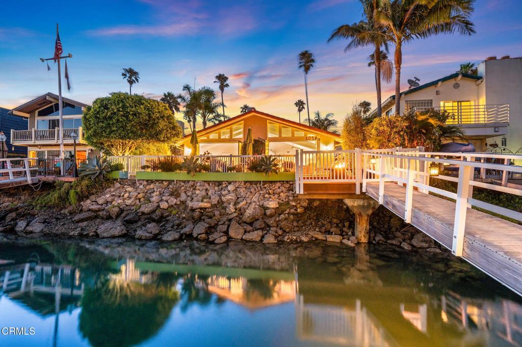 Welcome to 1016 Peninsula -- where Ventura Keys dockside living meets the beach just down the street. From your deck, take in the beautiful sunset views as well as Little Beach while dining al fresco.This single-level home features a smart, open layout with vaulted ceilings in both the living/dining area and the primary suite. Dramatic 8ft bifold doors in both the living room and primary bedroom seamlessly connects indoor and outdoor living, perfect for entertaining.Enter through double doors into a private front courtyard before stepping inside to be greeted by a stunning channel view. The kitchen is well-appointed with granite counters, stainless steel appliances, and abundant cabinetry.Additional highlights include: Two 1-car garagesA 35-foot dock for a boat, paddle boards, kayaks, and moreWood floors, recessed lighting Updated bathroomsMove-in ready conditionIdeally located on the channel, near the beach, shops, restaurants, downtown, and freeway access, this home truly embodies the Keys lifestyle. Come experience waterfront living for yourself.