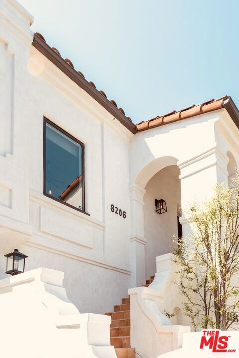 Rare opportunity to acquire a trophy Spanish duplex in prime Beverly Grove, recently renovated and tastefully restored with style, retaining charm and architectural character yet supplying with all contemporary amenities. Identical top and bottom units with private entry leading to a light and bright living room with wood flooring, recessed lighting, and fireplace. Formal dining room located off of the remodeled kitchen with all stainless-steel appliances, updated cabinetry and countertops, bar/island, and adjacent to the separate laundry room with a washer/dryer. The primary bedroom is located at the rear of the unit with updated bathroom and dual closet and two additional bedrooms and remodeled secondary bathrooms complete this ideal floor plan. With a gated driveway, 3 garages and large grassy pad shaded by mature tree, this timeless LA urban oasis is conveniently located by The Grove, The Beverly Center, Beverly Hills, Cedars-Sinai and Mid-Wilshire Business District.
