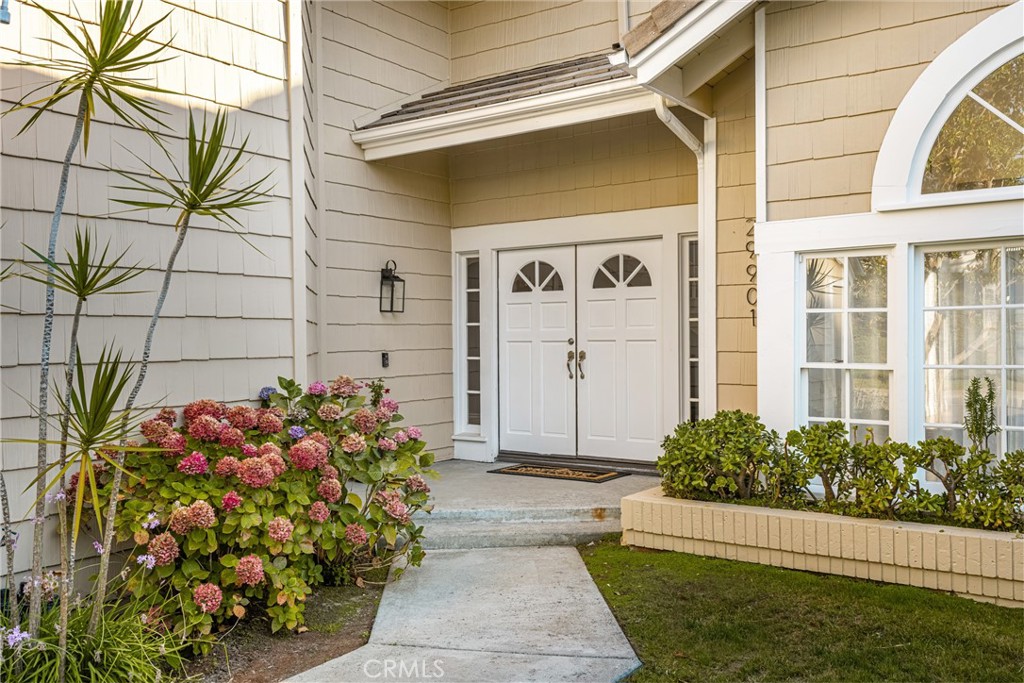 Welcome to 29901 Weatherwood - where space, comfort, and a great Laguna Niguel location all come together. Tucked into the Somerset Pointe community, this home offers nearly 3,500 square feet of flexible living just minutes from the beach, the freeway, and some of South OC’s best parks and trails. Step through the double doors and you’re greeted by rich hardwood floors and a layout that works WITH your lifestyle - not the other way around. The formal living room features a beamed ceiling, big picture window, and a two-sided fireplace that connects to the dining room—ideal for hosting holidays or just slowing down over a delicious meal. The kitchen has been thoughtfully updated with soft seafoam cabinetry, sleek pull-outs, newer lighting, and a crisp backsplash. The island bar seating opens to a casual dining area and the family room, where you'll find another fireplace and a built-in bar, because let’s be honest, that’s where everyone gathers anyway. Out back, the yard is set up for the best of SoCal living with a covered pergola, multiple seating areas, and room to lounge or dine al fresco. Need space for guests, extended family, or a quiet work-from-home setup? The downstairs den has its own patio and side entrance, making it ideal for long-term stays or added privacy. A full bathroom with a walk-in shower and backyard access is just down the hall - perfect after a beach day or summer BBQ. Your gift with purchase - a single-bay epoxy-coated garage with separate entrance - flex space, home gym, workshop, art studio...you name it. The two-car garage (also epoxied) has built-in storage and connects to a separate laundry room. Up the grand staircase, the primary suite shines with a cozy fireplace, beamed ceilings, and a peaceful seating nook. The ensuite bathroom brings in natural light through a skylight and features a spacious walk-in shower, jetted tub, and dual vanities. Down the hall are four more bedrooms, including one oversized front room that’s currently pulling double duty as an upstairs hangout space. Additional perks include a full PEX repipe, newer HVAC and ducting, fresh paint in most rooms, custom shades, and new exterior lighting. Take advantage of the award winning Capistrano Unified home schools, the Salt Creek Trail, Niguel Botanical Preserve, and beaches just minutes away. This one gives you options and lifestyle - and in the world today, that’s everything.