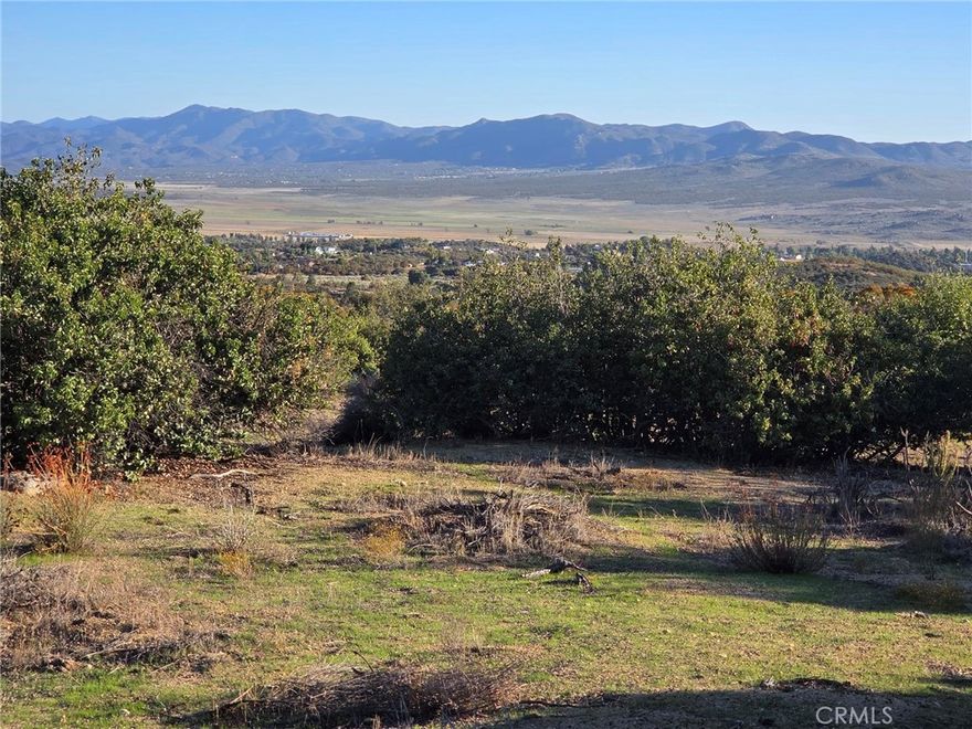 Wow, over 50 acres of beautiful land with SWEEPING VIEWS of the valley and surrounding mountains, WATER, and just off a paved road. Two parcels are being sold together. Very private but a just a quick 5 minute drive to town. There are several graded pads for building your dream home or ranch. Electricity is at the street. Owner may carry! Seller is motivated, come take a look and bring your offer. Also see land lender info in supplements.