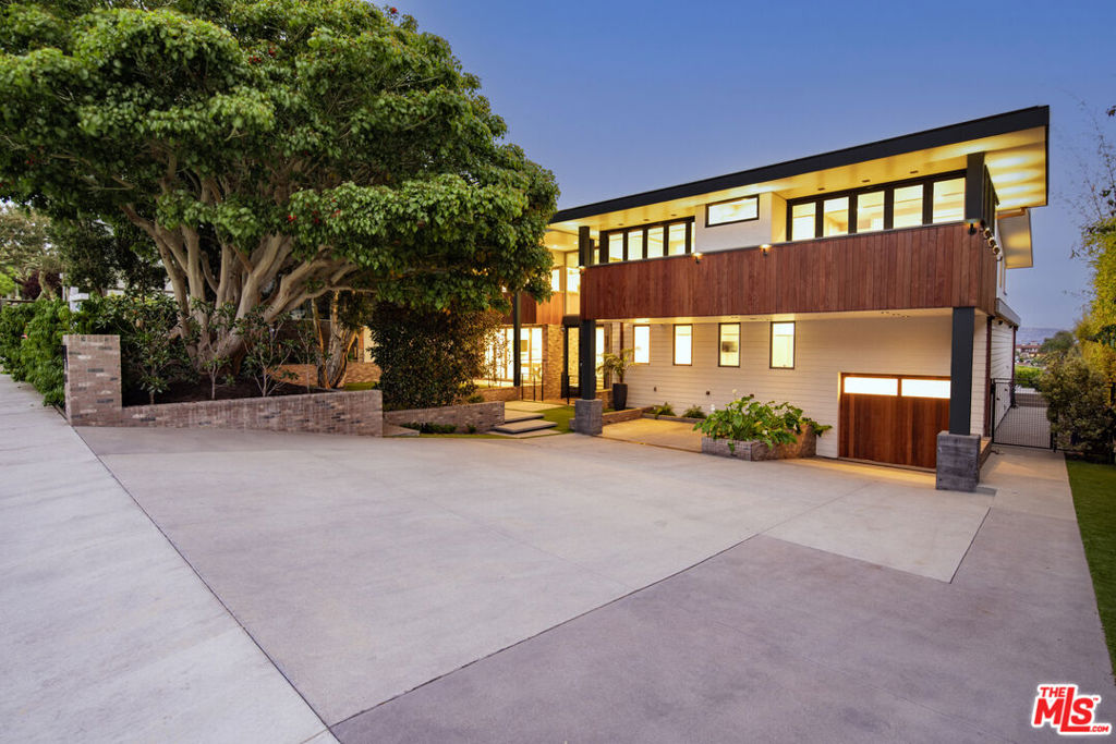 Welcome to 934 1st Street - an extraordinary architectural retreat perched in the heart of Manhattan Beach. With panoramic ocean views, refined design, and thoughtful functionality, this newly reimagined estate offers the ultimate Southern California lifestyle. Behind a bold facade of wood, glass, and brick, the home opens to light-filled interiors with soaring ceilings, wide-plank oak floors, and seamless indoor-outdoor flow. The main level features expansive living and dining areas, a chef's kitchen, and walls of glass that open to an entertainer's dream yard, complete with a sleek zero-edge pool, spa, and multiple lounge areas set against a sparkling ocean backdrop. Six bedrooms include a tranquil primary suite with a private view terrace, spa-like bath, and dual walk-in closets. A separate guest suite offers privacy and flexibility, while the lower level boasts a rare collector's garage with room for up to 15 vehicles. Designed for modern living with timeless appeal, this custom residence blends bold materials, curated finishes, and coastal sophistication - just blocks from the sand, Strand, and downtown Manhattan Beach.