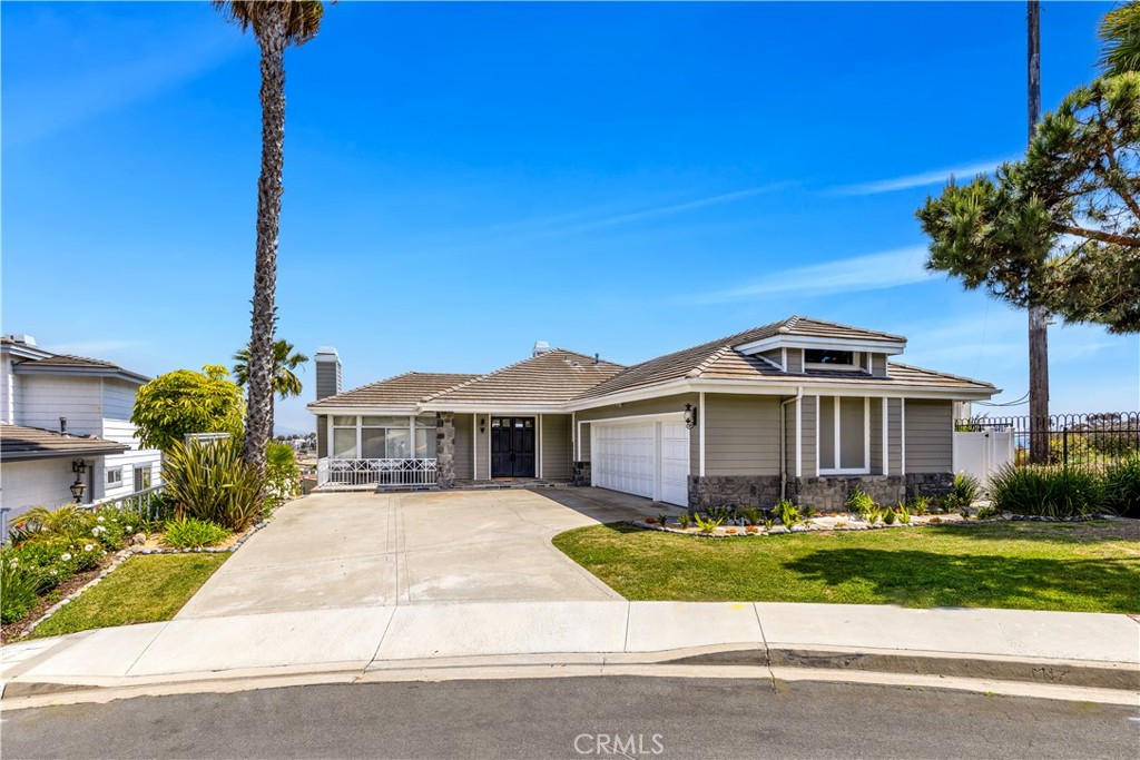 This immaculate, fully furnished home, offers a perfect blend of comfort, elegance, and coastal charm—ideal as a primary residence or a luxurious temporary getaway. Step inside and be greeted by soaring ceilings, abundant natural light, a seamless blend of easy to maintain engineered wood and tile floors, and all new top-quality fixtures and finishes throughout.The main level features a welcoming living room with a cozy fireplace and a spacious dining room—perfect for entertaining. The adjacent family room is a retreat of its own, complete with panoramic ocean views, a pool table, a large television, and access to a breezy balcony ideal for relaxing or enjoying a cocktail. The gourmet kitchen is a chef’s delight, equipped with all the necessities of daily living, boasting a center island with counter seating, casual dining nook, and ample windows that flood the space with light. A main floor bedroom with an ensuite bath offers privacy and stunning views. Downstairs, the primary suite showcases ocean views, a fireplace, direct access to the backyard, a luxurious dressing area, and a spa-like bathroom featuring a jetted tub, walk-in shower, and private toilet area. A third bedroom includes bunk beds, a desk, and sliding doors that opens to a serene backyard, and the oversized laundry room offers a futon for extra guests. Located just a short stroll from Doheny Beach and minutes to Dana Point’s vibrant Lantern District, you'll have easy access to world-class dining, surfing, boating, whale watching, and nearby luxury resorts. This is coastal living at its finest—come see it for yourself!