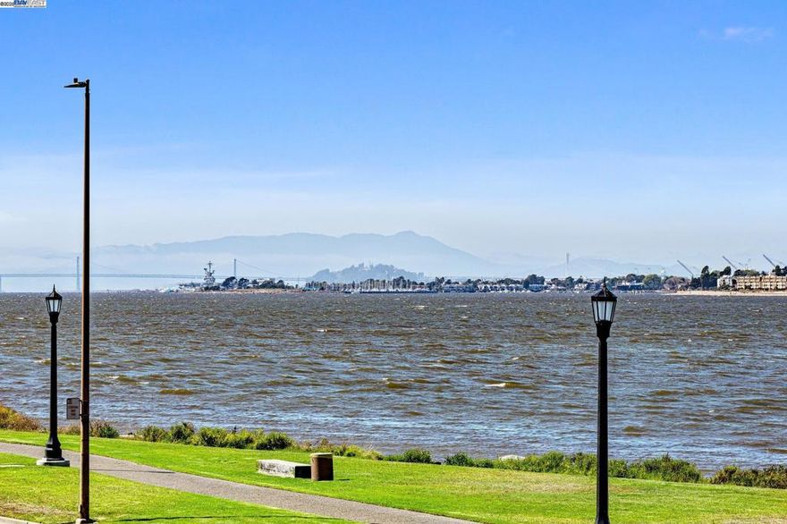 A rare waterfront duet home with sweeping bay and city views! This beautiful 3BD/3 BA Harbor Bay home in Harbor Pointe HOA features three en-suite bedrooms, a spacious open kitchen with granite counters, ample cabinetry and spacious living and dining area. There are three patio spaces in each bedroom and a two-car garage with laundry area. The home features an open great room with hardwood floors, a fireplace that centers the room, and large windows on three sides with stunning views of the SF skyline and bay. The spacious master bedroom enjoys the view of the morning sunrise. This home is directly across the street from the Shoreline Park and the seven-mile Bay Shore Loop Trail, the home is near top-performing schools and is moments from transportation options including the SF ferry.