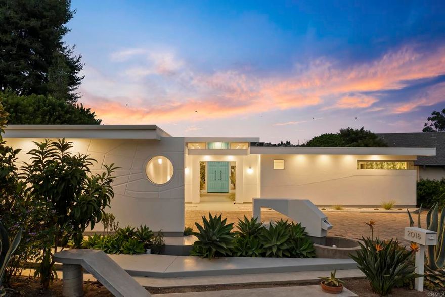 A one-of-a-kind mid-century modern home, situated on an idyllic serene cul-de-sac  that captures the essence of California living. Set on an expansive 0.42-acre lot in the heart of La Costa, this 3-bedroom, 2-bath single-level home offers 2,485 sq. ft. of timeless design, privacy, and style.  Built in 1966 and thoughtfully maintained, the home showcases signature mid-century elements — clean lines, floor-to-ceiling windows, and an open, light-filled floor plan. The spacious living room, anchored by a statement fireplace, flows effortlessly into the dining area and kitchen, creating a natural gathering space with views of the lush backyard.  The primary suite offers peaceful views and direct outdoor access, while two additional bedrooms provide flexible space for guests or a home office. Every detail reflects the home’s architectural integrity and original charm, balanced with modern comfort. Outside, a sparkling salt water pool and mature landscaping create a private retreat perfect for relaxing or entertaining. The oversized lot offers potential for future expansion or an ADU, making this property as practical as it is beautiful. Located minutes from Carlsbad’s beaches, golf, and top-rated schools, this is a rare opportunity to own a true mid-century modern treasure in one of North County’s most desirable neighborhoods.