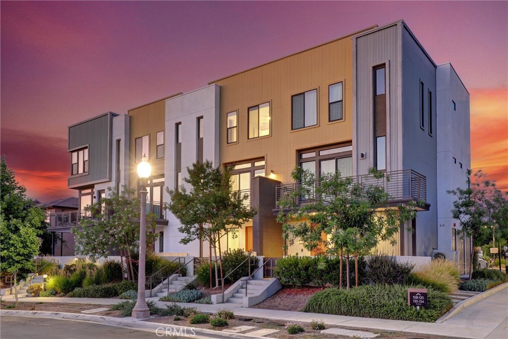 IRVINE SCHOOLS, WALK TO HIGH SCHOOL AND SOLIS SCHOOL!!! ENJOY THE SUNSET VIEWS AND GREAT PARK AMENITIES. Welcome to 104 Keeper, a beautifully upgraded townhome located in the heart of Irvine’s vibrant Great Park community. Built in 2021, this modern 2-bedroom, 2.5-bathroom home offers approximately 1,576 square feet of open-concept living space, designed with both comfort and style in mind. The light-filled main level features tile flooring and upgraded carpet, a spacious living and dining area, a powder room, and a gourmet kitchen equipped with granite countertops, stainless steel LG appliances, and sleek cabinetry. Upstairs, you’ll find two generously sized bedrooms with a sunset view from the master bedroom, each with its own en-suite bathroom, as well as a convenient laundry area with stacked LG washer and dryer.
Additional highlights include a private balcony overlooking tree-lined streets and a sunset view, an attached two-car garage, central heating and cooling, and energy-efficient leased solar panels that help keep utility costs low. Located just steps from top-rated IUSD schools like Cadence Park Elementary and Portola High School, and minutes from parks, shopping, dining, and freeway access, this turnkey home offers a perfect blend of suburban tranquility and modern convenience. Don’t miss your chance to experience the best of Great Park living at 104 Keeper.