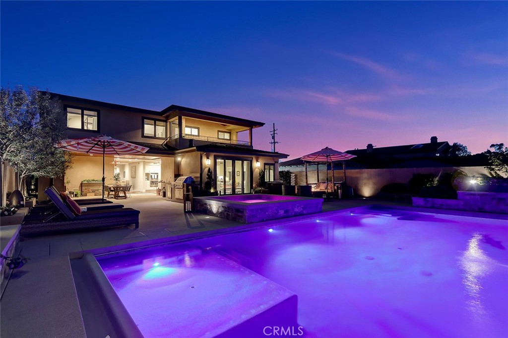 Custom built in 2016 on a 7,500 square foot lot, this stunning coastal contemporary home was thoughtfully designed with an emphasis on functionality and maximizing indoor/outdoor living. Unlike a typical spec home that maxes out interior square footage and sacrifices the yard, this home offers a refreshing take with no wasted space and one of the most incredible backyards in Manhattan Beach. Open the front door and you're immediately greeted with soaring ceilings and a wide open great room that features a stunning zero post corner double pocket door system. This open design seamlessly blends the jaw dropping indoor and outdoor spaces. The spacious outdoor covered patio has a natural stone fireplace with an outdoor TV, stain grade tongue and groove ceilings, surround sound, and a fully stocked outdoor kitchen with a built in BBQ. Surrounded by mature landscaping, this private oasis of a yard has a built in gas fire pit as well as a massive pool and spa featuring a baja shelf, waterfall feature, and multiple seating/lounging areas. The chef's kitchen is perfectly situated next to the living and dining areas that open up to the backyard. Truly an entertainer's dream with a massive center island with seating, Sub zero and Thermador appliances, a double oven, butler's pantry, full size built in wine fridge, and a plethora of additional cabinet storage. Ideal bedroom layout with one guest bedroom and a full bathroom downstairs, a pool bath accessible from inside or outside, as well as a large office/flex space that can also serve as a playroom or gym. Upstairs you will find three spacious bedrooms each equipped with a walk in closet and bathroom en suite as well as an oversized laundry room with additional storage. Generous primary suite with vaulted ceilings, a spacious walk-in closet, a covered patio overlooking the backyard, and a large bathroom with dual vanities and a soaking tub. Additional features include custom hand hewn mahogany floors throughout, central AC, and a finished 2 car garage with a sink and storage space. Come check out this quiet family friendly neighborhood boasting one of the flatest and most accessible streets in the area!