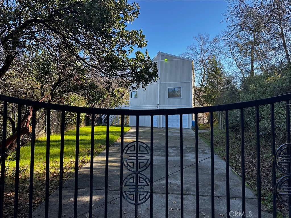 Calling all investors: Motivated seller for this prestigious mountain RETREAT set privately behind a gated setting & high above the surrounding hills and lake for ultimate privacy and spectacular views. Perfect vacation home or Airbnb, this home is close to shopping, the lake, Highway 20 for easy commuting to Ukiah. This property is set on nearly 1/2 acre which allows plenty of parking for cars, boats, toys. Featuring 3 bedroom, 3 bath for this tri-level home with open floor plan, updated kitchen open to living room area, vaulted ceilings and providing a spacious 2,184 square feet of living space. Entry on ground level or up stairs to main living area. One main level bedroom and 2 upstairs bedrooms PLUS ground level BONUS ROOM, entertainment room or additional bedroom with its own gated yard. New kitchen countertops, new cabinets, new flooring and new appliances (dishwasher, stove, refrigerator). New French doors on main level. Attached garage with new garage door, new water heater, new paint in bedrooms, new vanity top and mirrors in upstairs bath, new window blinds, roof less than 10 years old. Fully fenced with plenty of usable outdoor space and covered patio, mature trees and grass area. Clear Lake is part of California's Wine Country which includes Napa, Sonoma and Mendocino Counties with Lake still boasting an affordable Real Estate Market. It includes nine American Viticultural Areas and around 20 bonded wineries. Lake County regularly ranks on the list for best air quality. One of California's hottest new wine destinations, Lake County is home to Clear Lake, the largest natural freshwater lake in CA and Mount Konocti, an ancient volcano for excellent hiking, biking and fishing opportunities. Clean air, scenic beauty, fine wines and unsurpassed recreation await! Head to the Lake! (visitcalifornia.com & lakecountyca.gov).