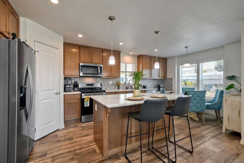 Discover effortless 55+ living in this beautifully designed 2024 manufactured home in the peaceful and highly desirable Sundance Mobile Home Park in North Escondido. This modern, turn-key home offers 3 bedrooms, 2 bathrooms, and an open-concept layout filled with thoughtful upgrades. Enjoy a stylish kitchen with a central island, sleek countertops, stainless steel appliances, and modern cabinetry—perfect for everyday living or entertaining. The spacious main suite offers a walk-in closet and en-suite bath, while two additional rooms provide flexibility for guests, a home office, or hobbies. Upgraded finishes include durable flooring, plush carpet in the living room and bedrooms, modern baseboards, and A/C system installed in 2024. A 2-car covered carport, laundry area, and private storage shed add convenience. Located in a quiet, 88-home community with resort-style amenities—including a heated pool, spa, clubhouse, game area, guest parking, and more—in a pet-friendly setting. Close to the 78 & 15 freeways, shopping, dining, and just a short drive to the coast, this home is the perfect blend of comfort, convenience, and community. Don't miss your chance to make it yours!