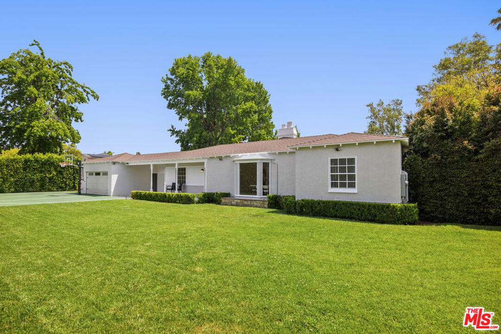 Welcome to 5432 Fulton Avenue a meticulously updated single-level home nestled on an expansive 12,555 sq ft corner lot, just minutes from the best of Sherman Oaks. Spanning approximately 2,000 sq ft, this light-filled residence seamlessly blends timeless charm with contemporary style, offering the perfect canvas for modern family living and entertaining. Step inside to discover three spacious bedrooms, including two primary suites one featuring a walk-in closet and a luxurious ensuite bathroom. The inviting floor plan showcases multiple living and dining areas, hardwood floors, recessed lighting, and an abundance of natural light through oversized windows and French doors. The kitchen features a sunlit breakfast nook, ample storage, and direct flow into the main living spaces, ideal for gatherings both big and small. Dual fireplaces provide cozy focal points in both the living and dining rooms, adding warmth and architectural interest. Outdoors, the magic continues with a lushly landscaped backyard that offers a full-size sport court, built-in trampoline, and a generous lawn perfect for play, pets, or entertaining under the California sun. This turnkey gem offers a rare opportunity to own a fully usable lot in one of the Valley's most desirable neighborhoods. Whether you're upsizing, relocating, or planting roots, 5432 Fulton Ave is ready to welcome you home.