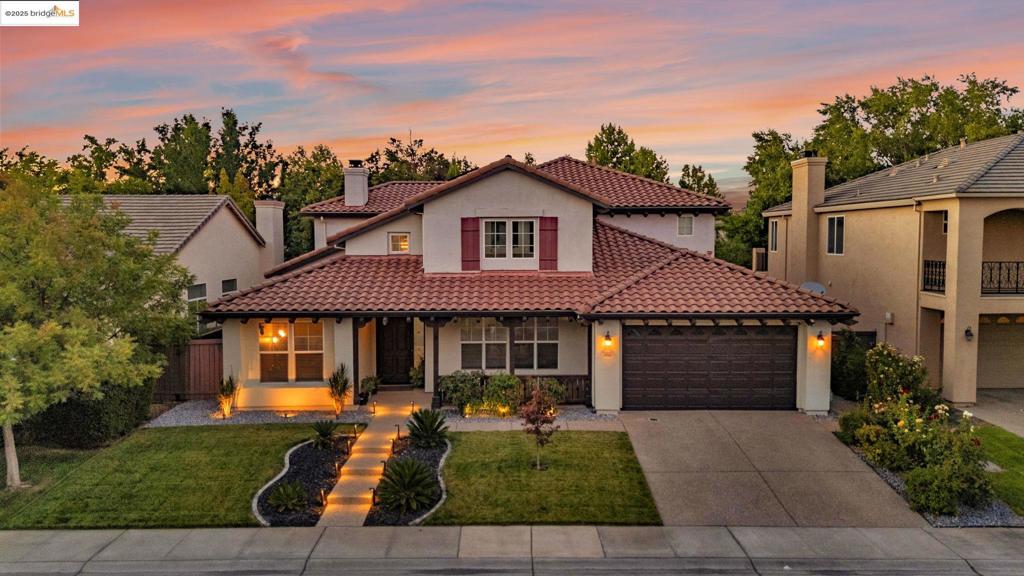 This beautiful Smart Home offers an impressive 3,747 sq ft of meticulously crafted living space, including 4 spacious bedrooms and 3.5 bathrooms. A sizable office can easily serve as a 5th bedroom. With over $40,000 invested in upgrades, this flawless property is located in a peaceful Natomas neighborhood and shopping, just a short walk from the highly regarded Natomas Charter School and under 10 minutes from the airport. Step inside to a warm and welcoming ambiance, enriched by fresh paint in soothing neutral shades. The home features stunning new chandeliers and a modern stainless steel oven/microwave combination. The kitchen is a culinary delight, complete with a farmhouse sink, a generous range, a custom stained glass backsplash, and distinctive light fixtures. Conveniently, a sought-after bedroom and full bath are on the main level, while the primary suite offers a luxurious rain shower and Bluetooth-controlled lighting and music, ensuring a lavish experience. Enjoy the refined travertine entryway and hardwood flows throughout, including the staircase. With solar panels for energy efficiency, this versatile home enhances both luxury and practicality. Don’t miss your chance to claim this extraordinary property!