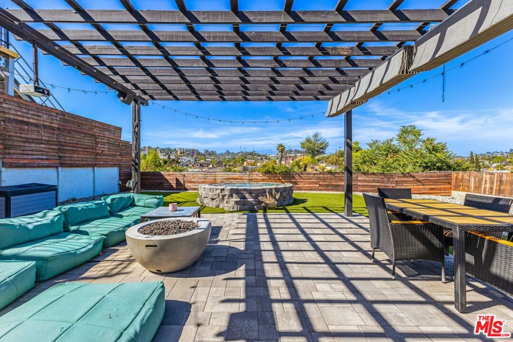 A rare flat-lot view home with serious style, guest house income, Airbnb potential, and no LA rent control. Perched at the top of the hill, this one-of-a-kind 1908 bungalow sits on a wide, flat 6,682 square foot lot. It's a true unicorn where sweeping views meet walkable terrain and seamless indoor-outdoor flow. No steep stairs, no hillside hassle, just sunshine, skyline, and total vibe. The main 2-bedroom, 1-bath home is full of curated charm, vintage soul, and elevated finishes. It's also a top-rated Airbnb with a glowing track record and five-star reviews that can transfer to the next host. Downstairs, the chic 1-bedroom guest house has its own entrance, kitchen, bath, and living space, adding approximately 506 bonus square feet in addition to the 834-square-foot main home. The guest house is currently bringing in $2,200 per month on a short-term lease, in addition to income generated by the main home's Airbnb, making this a rare income-flex setup. Step outside to a backyard that feels like a private retreat, with a custom-built pergola, cozy firepit, outdoor movie setup, and a 10-foot soaking pool framed by open-sky views. Major upgrades include roof, plumbing, electrical, sewer, and windows. Located in unincorporated LA County, you are not subject to LA City rent control or short-term rental restrictions. Just minutes to Highland Park, DTLA, and all your favorite Eastside spots, this home doesn't just check every box. It sets the bar.