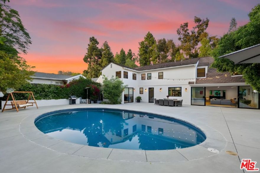 Stunningly renovated 4-bed, 4-bath, 3,131 sqft Westwood retreat, now upgraded with brand-new high-end designer furnishings, an advanced AI-powered security system with facial recognition, a premium whole-home sound system, and a newly installed oversized safe. Set behind lush, mature hedging for ultimate privacy, this exquisitely remodeled home welcomes you with a grand covered entry and elegant wooden door, opening into a bright, open floor plan designed for seamless indoor-outdoor living. A graceful winding staircase complements the sunlit formal living room, featuring a stunning fireplace and Fleetwood sliding doors leading to the entertainer's dream backyard, complete with a sprawling patio, illuminated oval pool, and lush landscaping with fruit trees. The chef's kitchen boasts a spacious island, built-in breakfast bar, and top-tier stainless appliances, while the first floor also offers a stylish guest suite, full bath, and large laundry room. Upstairs, the lavish primary suite is a true sanctuary with a custom walk-in closet, spa-inspired bath, soaking tub, and oversized glass steam shower, alongside expansive guest bedrooms with beautifully designed baths. A finished garage serves as a flexible space for a gym, office, or studio. Located in prime Westwood, this exceptional home offers the perfect blend of luxury, security, and modern convenience, just minutes from the best dining, shopping, and entertainment.