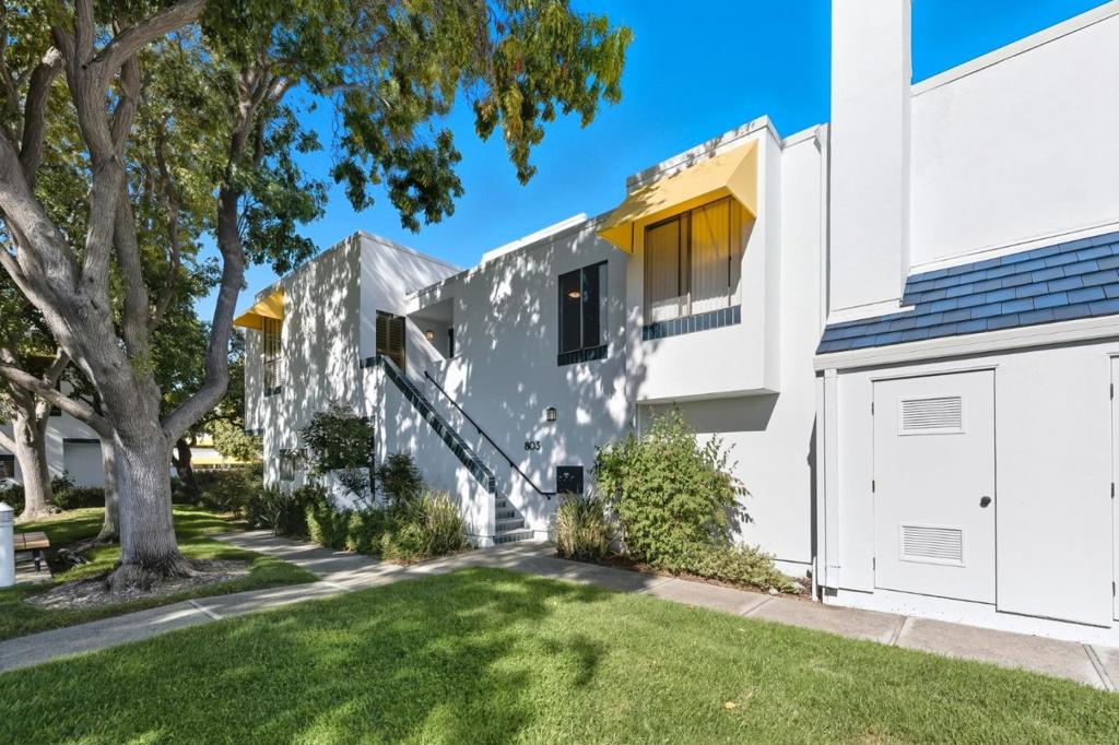 Welcome to this highly desirable top-floor, end-unit condo in the charming "Islands" community. This home offers a resort-like lifestyle with an abundance of natural light streaming in through large windows and two skylights. Gather around the cozy gas fireplace in the vaulted-ceiling living room, which opens to a tranquil balcony offering peaceful greenbelt and garden views. The spacious primary suite is a private sanctuary, complete with its own balcony and ensuite bathroom, while a generous second bedroom provides a bright and comfortable space for family or guests. Enjoy the ease of an in-unit laundry and a two-car tandem garage. Community amenities include a sparkling pool, and the prime location puts you near top-rated schools, parks, local dining and shopping and easy access to highways 92/101.