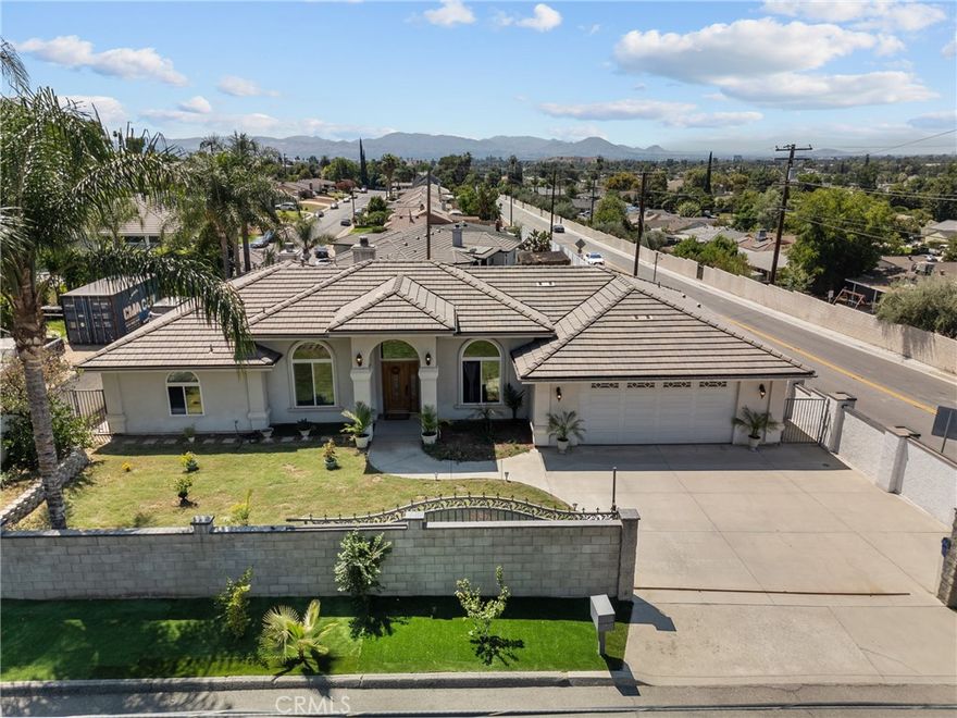 Nestled in a highly desirable neighborhood, this stunning one-story home offers the perfect blend of comfort, style, and functionality. Built in 2005 and set on an expansive 11,500 sq ft lot, this beautifully maintained property boasts 3 spacious bedrooms, 3 full bathrooms, and exceptional curb appeal with lush landscaping and a gated front entry for added privacy.  Step inside to find a warm and inviting formal living room that flows effortlessly into a cozy family den featuring a charming fireplace—ideal for relaxing evenings or entertaining guests. The chef’s kitchen is a true highlight, showcasing elegant granite countertops, newer cabinetry, and high-end stainless steel appliances. With an open-concept layout, the kitchen overlooks the family room and connects to a large secondary living area, creating a bright and airy space perfect for everyday living.  Each of the three bedrooms is generously sized with ample closet space, offering comfort and privacy for family and guests alike.  Step outside into your private backyard oasis, where a large in-ground pool awaits—perfect for summer fun and outdoor entertaining. The spacious yard provides endless possibilities for gatherings or simply relaxing in a serene setting.  Additional features include high vaulted ceilings with elegant crown molding, direct access 2-car garage (side-by-side), gated front yard for added security, convenient location near the 210 freeway and Cal State San Bernardino.  This is more than just a house—it's a place to call home. Don’t miss your opportunity to own this meticulously maintained gem.