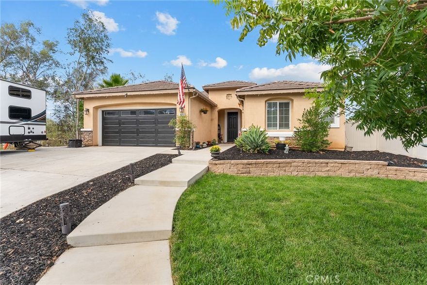 This beautiful upgraded single-story home sits on .86 of an acre at the end of the expansive cul-de-sac, offering a peaceful, private sanctuary. The interior features appealing upgrades, including tile floors, built-ins, and granite countertops, and with many special touches throughout. The great room boasts a fireplace, space for a big-screen TV, and adjoins the kitchen, which has a massive island, extra counter space, and plenty of cabinets. The floorplan is designed with three separate bedroom areas. A very large En-suite includes an adjoining bath with a soaking tub, separate shower, and walk-in closet. The shared En-suite consists of two good-sized bedrooms, a shared bathroom, and a built-in linen cabinet in the hallway. You will enjoy relaxing and entertaining on your covered patio. The huge backyard is fun filled with above ground pool, outbuilding that is currently the hens barn and additional fenced outdoor roaming area for the Hens. Tranquil pond with fish, and still plenty of room for your custom touches.  The additional land has room for Horses and maybe a round pen, or your own vineyard, orchard or workshop or Sports area. Several possibilities for the RV's and Toys.  You experience the quaintness of a neighborhood, yet the feeling of being in the wide open country and NO HOA.