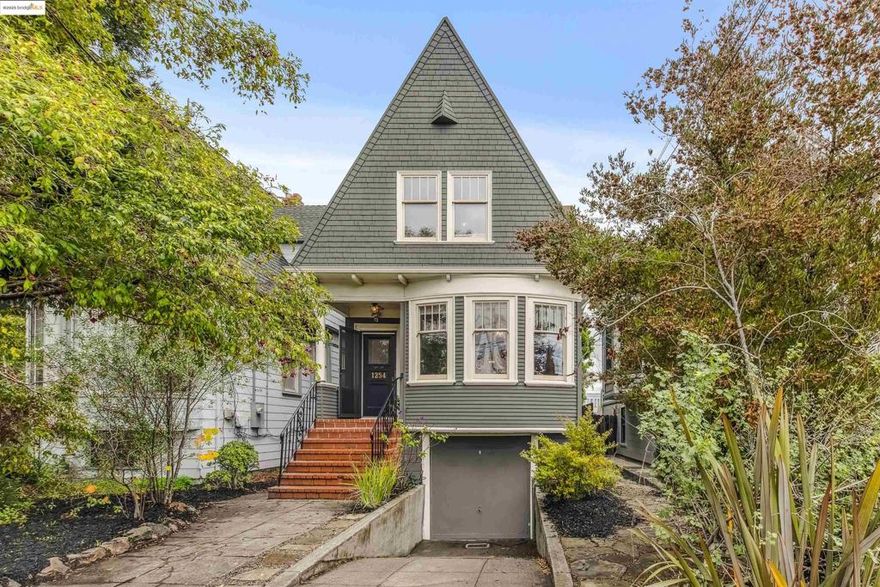 Built around 1895, this striking High-Peaked Colonial Revival home showcases the scale and craftsmanship of the Victorian era, highlighted by tall ceilings, beautiful millwork, and warm natural light throughout. The kitchen has been reimagined with a vintage-inspired aesthetic and modern function, featuring extensive marble counter space for cooking and gathering.  The main level includes a comfortable primary suite, while the upper floor offers three additional bedrooms and a second full bath. Recent improvements include an updated forced-air furnace and ducting, refreshed gutters and downspouts, newer rear roof, and new water heater.  Located close to Alameda’s highly regarded K–12 schools, the home is also a short stroll from Park Street’s popular restaurants, cafes, and local shops. Crown Beach—known for its wide stretch of soft sand and calm bay waters—is just minutes away, offering year-round outdoor enjoyment.
