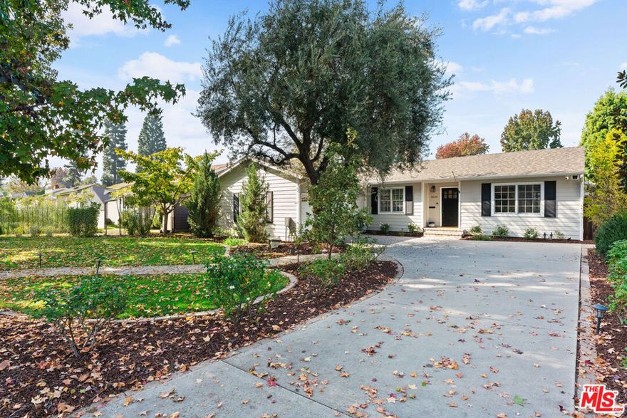 This storybook Chandler Estates residence embodies timeless California living with its graceful charm, quality craftsmanship, and modern comfort. Set on a beautifully landscaped 9,600 square foot lot with over seventy feet of frontage, it is framed by mature trees and a lush front garden that create a sense of privacy and warmth from the moment you arrive. Inside, the single-level floor plan offers effortless flow from the chef's kitchen to the dining and living areas, all filled with natural light and thoughtful design. The kitchen is a true centerpiece with custom cabinetry, quartz countertops, and premium appliances including a Wolf range, Bosch dishwasher, and LG refrigerator, ideal for both everyday use and entertaining. The primary suite serves as a peaceful retreat with a spa-inspired bath featuring dual vanities, a soaking tub, a frameless glass shower, and a generous walk-in closet. Two additional bathrooms have been elegantly updated with designer finishes. Interior highlights include crown molding, recessed lighting, fresh designer paint, and dual-pane Pella windows that bring in the beauty of the outdoors. Sliding doors open to a private backyard oasis with a deck off the dining room, a sparkling saltwater pool, and a spacious grassy yard surrounded by mature landscaping and blooming gardens. Thoughtful upgrades include owned solar, a newer roof, updated electrical systems, a replaced sewer line and main tie-in, two tankless water heaters, and central heating and air conditioning. With a two-car garage and extended driveway parking, this home sits proudly on one of the most picturesque, tree-lined streets in Chandler Estates, offering a rare blend of character, comfort, and sophistication.