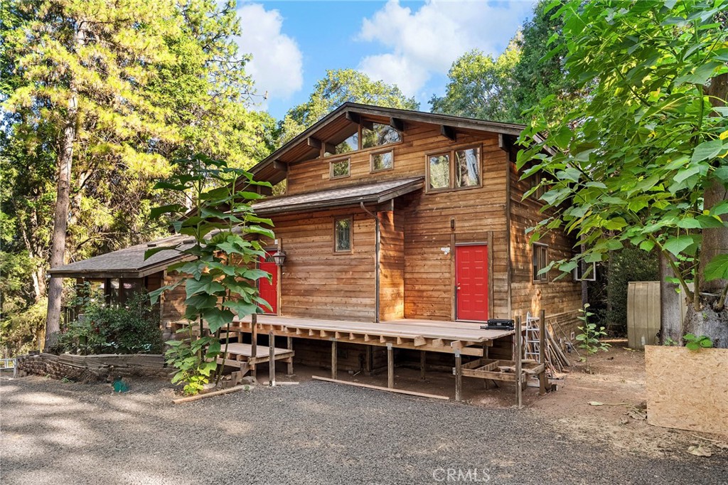 Peaceful private mountain home nestled among trees and wildlife sitting on roughly 14 acres! The home offers two primary suites, one on lower level and one on upper level, with additonal bonus room for 3rd bedroom upstairs. Bedrooms have new carpeting and spacious bathrooms with double sinks, jacuzzi tubs along with walk in showers. The main heart of the home offers, beamed ceilings, lots of windows for views and natural light, an open floor plan, connecting the living, dining, kitchen, and den areas. The den is an inviting space for intimate gatherings or quiet contemplation. The laundry room, equipped with a sink, cabinets, and a convenient half bath, with exterior service door to front deck. The kitchen showcases a newer fridge, double ovens, garbage compactor, microwave, dishwasher, and an appliance garage, complemented by ample pantry space. A gas log fireplace adds warmth to the living room, while ceiling fans throughout ensure optimal airflow. Downstairs, a spacious unfinished basement invites endless possibilities for customization, allowing you to tailor the space to your specific needs and preferences. Step outside to enjoy three decks, each providing a tranquil retreat amidst the natural beauty, with the main front deck just finished and all new with custom lattice work railings. Over the last year the seller has installed full owned solar with two Enphase battery backs ups and a car charging hook up. New roof in 2024 as well prior to Solar, new high end split systems for heat and air, one in main room downstairs and two units in each bedroom. Seller has also completed new decking, added a covered carport, gravel in driveway, and created a wonderful fruit tree garden with an amazing array of choices. The home sits on roughly 14 acres, solid good well with new engagement box for smooth motor operation and there is also a year round spring in the center of property below the home. If you're looking for peace and tranquility, this may just be the one!!
