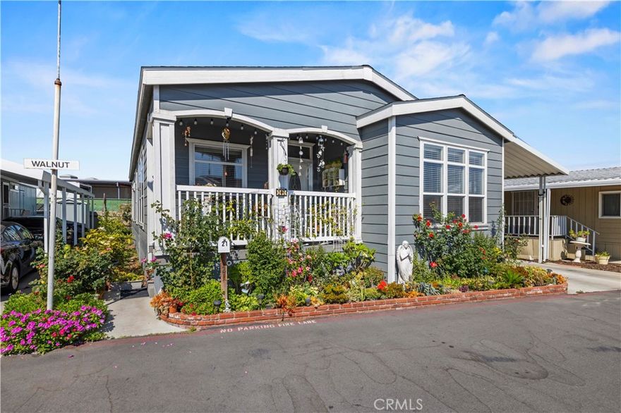 Welcome to 21 Walnut Via, a beautiful 3 bedroom, 2 bathroom manufactured home built in 2017 that combines modern finishes with functional design in the heart of Anaheim. From the moment you step inside, you’ll appreciate the open and inviting floor plan featuring a great room with 9’ flat ceilings, crown molding, and laminate wood flooring throughout the main living areas.



The gourmet kitchen is a true centerpiece of the home, designed with a huge center island perfect for casual dining, entertaining, or extra prep space. Abundant cabinetry, and built-in storage in the kitchen and laundry room provide ample space to stay organized. This thoughtfully designed kitchen also includes stainless steel appliances: a side-by-side French door refrigerator, stove, microwave, and dishwasher. Adjacent to the kitchen, you’ll find both an eat-in breakfast area and a formal dining room, creating flexible spaces for everyday meals or hosting larger gatherings.



The primary bedroom suite is generously sized, offering a peaceful retreat complete with a walk-in closet and a luxurious bathroom featuring a large walk-in shower. Two additional bedrooms are versatile for family, guests, or use as a home office.



Additional highlights include dual-pane energy-efficient windows, central air conditioning, and a covered porch, perfect for relaxing or entertaining outdoors. Parking is available for two or more vehicles, providing convenience and ease for households with multiple cars.



This home offers both style and comfort with an emphasis on functionality. Its prime location places you near shopping, dining, entertainment, and Anaheim’s popular attractions. Whether you are looking for your first home, downsizing, or simply seeking a move-in ready property, 21 Walnut Via delivers the space, features, and lifestyle you’ve been waiting for.