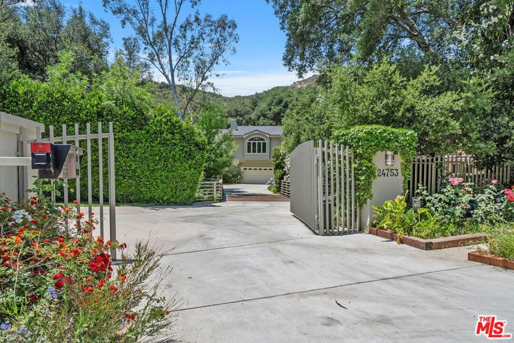 Stunning Calabasas Estate on over 2 Acres in Calabasas, this beautifully maintained estate offers the perfect blend of luxury, privacy, and space. Set on over 2 acres of lush, landscaped grounds with a dog run for the dog lovers the property features 4 spacious bedrooms and 4 elegant bathrooms, ideal for both comfortable living and stylish entertaining.Step outside to a serene oasis with a sparkling pool, surrounded by mature trees and manicured gardens that create a truly tranquil setting. Whether you're hosting gatherings or enjoying quiet mornings, the outdoor space offers endless possibilities.