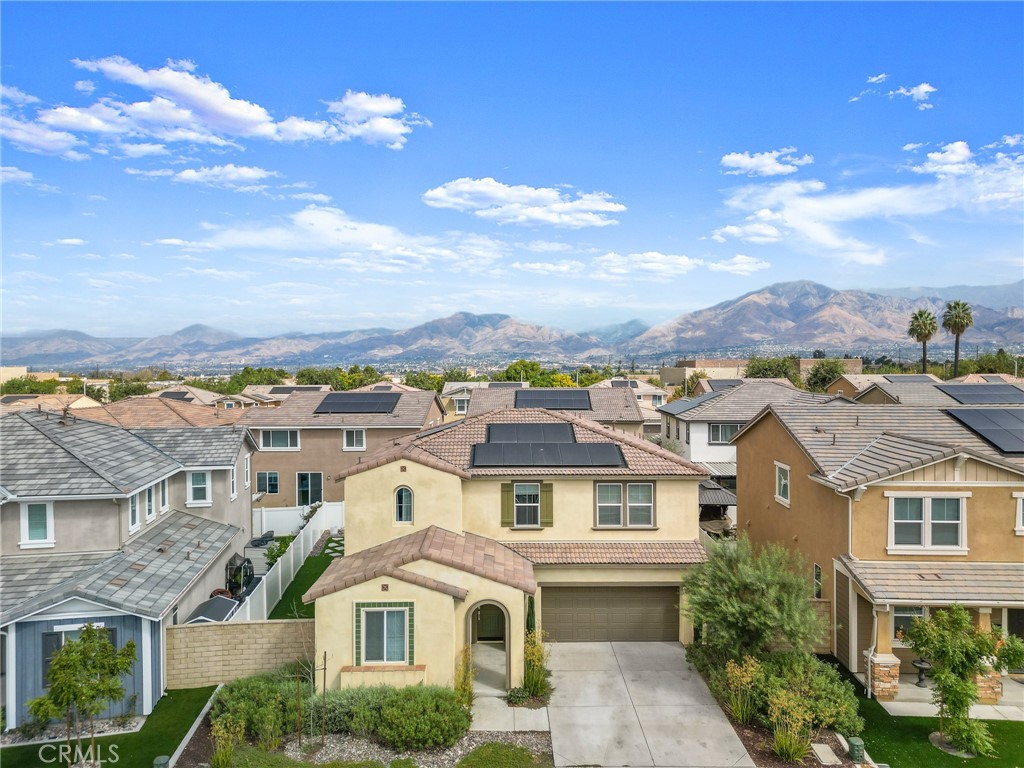 Built just 3 years ago and better than new, this beautifully upgraded Redlands home offers 4 bedrooms, 3 bathrooms, and a versatile layout. Downstairs includes a bedroom and full bath—perfect for guests or multi-generational living—plus a flexible bonus room ideal for a home office, gym, or potential 5th bedroom. The open-concept living area and kitchen are filled with natural light from numerous windows, all adorned with custom designer Roman shades, found throughout the entire home. Upstairs, you’ll find a generous loft, two secondary bedrooms, a full bath, and a convenient laundry room. The expansive primary suite features two walk-in closets and an ensuite bath with a soaking tub, walk-in shower, and dual-sink vanity. Enjoy low-maintenance outdoor living in the fully hardscaped backyard, complete with artificial turf, pavers, and extended concrete. Additional upgrades include PAID-OFF SOLAR, stunning engineered hardwood flooring, and a two-car garage outfitted with custom Swisstrax flooring tiles. Located within the top-rated Redlands Unified School District, residents also have access to a community park, playground, and picnic area. Just minutes from Citrus and Mountain Grove Shopping Centers and close to the 10 and 210 freeways for easy commuting. This home checks every box—schedule your private showing today!