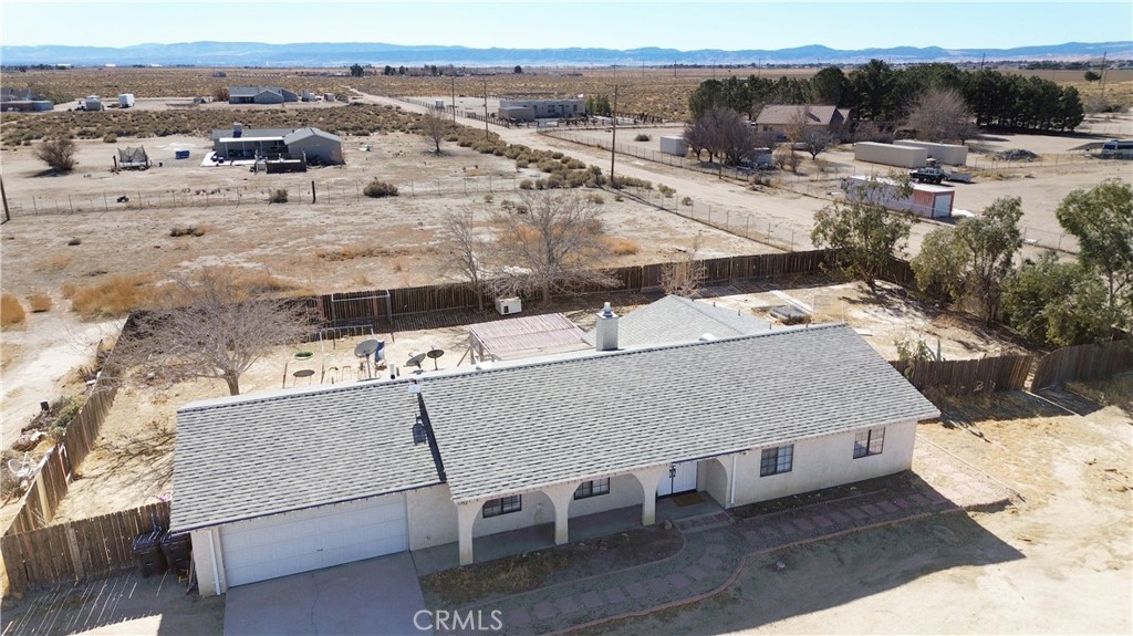 Welcome to this charming single-story home nestled on a spacious 2.5-acre lot in the city of Rosamond! Offering an open floor plan, this home features 3 comfortable bedrooms and 2 well-appointed bathrooms, providing plenty of room for families of all sizes. The attached 2-car garage adds convenience and storage space. The property also includes a versatile additional structure, perfect for storage, a workshop, or anything you need. With 2.5 acres of land, the possibilities are endless! There’s ample space for expanding the home, creating outdoor living areas, and more. Whether you dream of raising farm animals, cultivating a garden, or simply having space to play, this property offers the perfect canvas to bring your vision to life. Conveniently located not far from the 14 Freeway, you're also close to shopping and amenities for added convenience. This is your opportunity to own a slice of peaceful country living with the flexibility to create your ideal lifestyle—schedule a tour today and see all the potential this property has to offer!