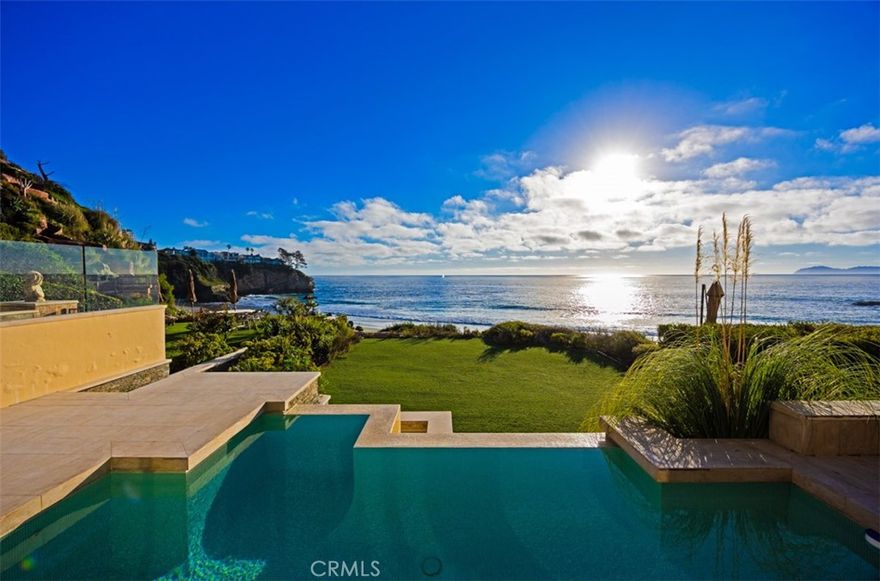 A truly unparalleled offering, this rare oceanfront estate in the coveted, guard-gated enclave of Three Arch Bay presents an extraordinary chance to shape one of Laguna Beach’s most significant coastal properties. Poised above the community’s iconic private cove, the residence commands sweeping, unobstructed views of the Pacific and enjoys direct access to the sand—an amenity few homes along the coast can claim. Set on a sprawling, flat oceanfront parcel with a pool, spa, and meticulously landscaped grounds, the property offers a spectacular setting where land, sea, and architecture converge. The existing structure—stripped to the studs and ready for transformation—provides an exceptional framework for the next owner’s vision. Towering ceilings, vast expanses of glass, floating staircases, and a commercial-grade elevator lay the groundwork for a world-class contemporary retreat that lives in rhythm with the shoreline just beyond. Every level opens to expansive terraces and floor-to-ceiling sliding walls of glass, dissolving the boundary between indoors and out while capturing the drama of the coastline. The lower level spills effortlessly onto the pool terrace and oceanfront lawn, creating a breathtaking backdrop for everyday living and unforgettable gatherings. Thoughtfully designed in collaboration with FRANK and CJ Light, the home is offered with fully approved plans and permits—an invaluable advantage that allows construction to commence immediately, saving years of time and complexity. The plans also provide the ability to expand, including options for two additional bedrooms and a 700-square-foot ADU, further enhancing the estate’s scale, functionality, and value. Residents of Three Arch Bay enjoy exclusive access to an array of private community amenities, including 24/7 guarded entry, a residents-only beach, clubhouse, tennis and basketball courts, playground, and beautifully maintained parks. Moments from world-renowned beaches, celebrated restaurants, and premier schools, this extraordinary estate represents a once-in-a-generation opportunity to craft a legacy home along one of Southern California’s most treasured stretches of coastline.