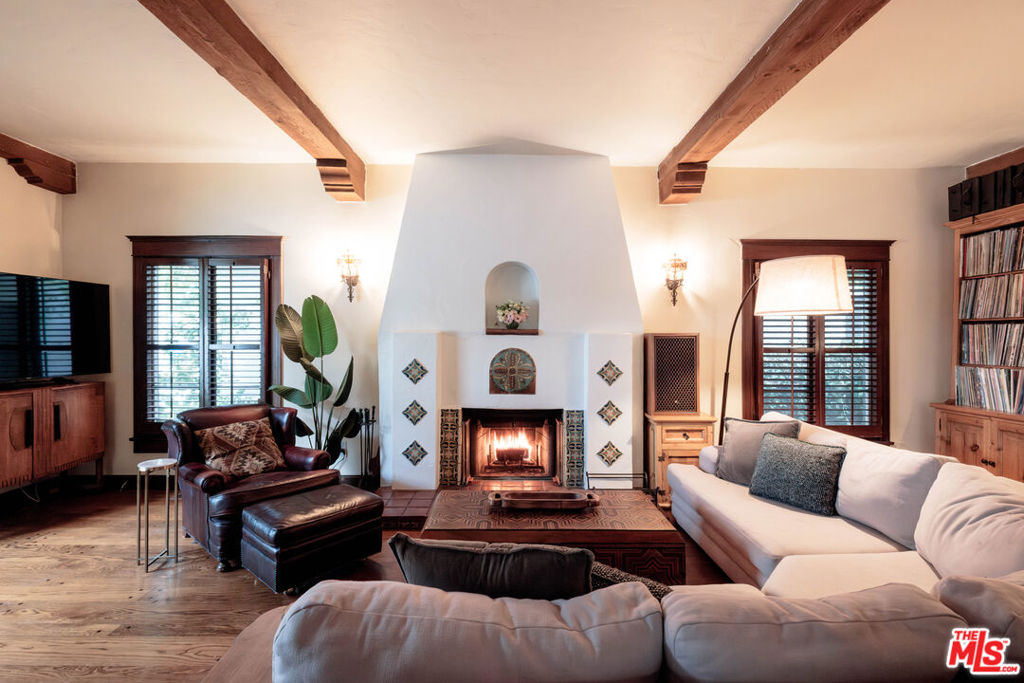 Nestled on a picturesque corner lot in Glendale's coveted Rossmoyne neighborhood, this exquisite 1930 Spanish-style home seamlessly blends historic charm with modern comfort. A gated entry leads to a private courtyard, perfect for morning coffee or evening gatherings under the stars. Inside, graceful archways, intricate hardwood inlays, and a striking staircase reflect the home's timeless elegance. The living room features eye-catching wood beam ceilings and a stunning arched window that floods the space with natural light. French doors lead out to the courtyard offering a seamless indoor-outdoor flow. The beautifully rebuilt fireplace anchors the space creating a warm and inviting atmosphere.The kitchen is fully equipped and boasts a spacious island and is thoughtfully positioned next to the dining room to ensure effortless hosting. A versatile flex space nearby can serve as a quaint office, or creative space. The main-floor bedroom provides relaxing guest accommodations, with an intricately tiled bathroom close by.The backyard is a secluded retreat that reflects the homes design and elegance. Featuring ivy-draped walls and a sparkling pool, you'll want to lounge all day. Upstairs, three additional bedrooms await. The primary suite features peek-a-boo mountain views, a spacious closet, and ensuite bathroom that exudes vintage charm. Two additional bedrooms share an equally detailed hall bath. Down the hall a cozy reading nook overlooking the tree tops offers a serene escape. From the moment you arrive, it's clear this home is something special.