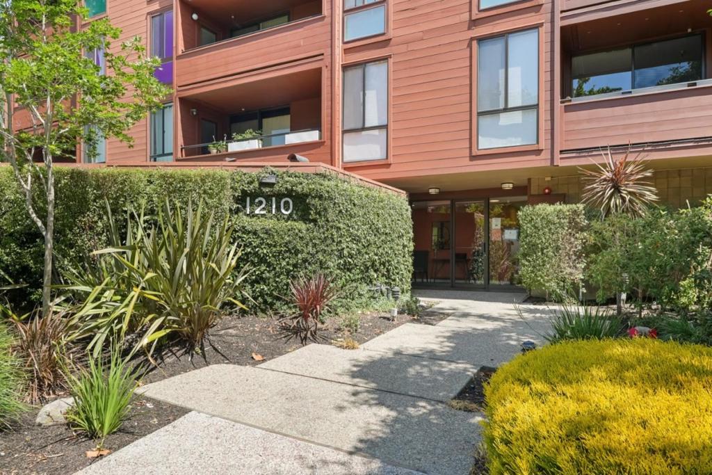 Experience upscale living in this beautifully renovated, top-floor, end-unit condo located just two blocks from Burlingame Avenue. Walk to boutique shops, gourmet dining, CalTrain, top-rated schools, and vibrant community amenities steps from your door. This single-level residence blends comfort and modern living with four skylights (!), rich carpet, and views of the bustling downtown. The dining area and living room, filled with sunlight from numerous windows, share access to the sunny deck, with a cozy fireplace illuminating an inviting atmosphere. A remodeled kitchen boasts corian countertops, ample cabinetry, and stainless steel appliances. The primary suite includes a walk-in closet, a sliding glass door to the deck, and full shower. The second bedroom is quietly tucked down the short hall, just steps to the second bath with shower over tub. Secure, gated, and covered parking includes two deeded spaces, two storage units, and elevator access. The complex offers a pool, hot tub, rec room, garden landscaping, and same-floor shared laundry. Conveniently located in the heart of Burlingame, this upscale residence combines luxury, convenience, and an unbeatable location.