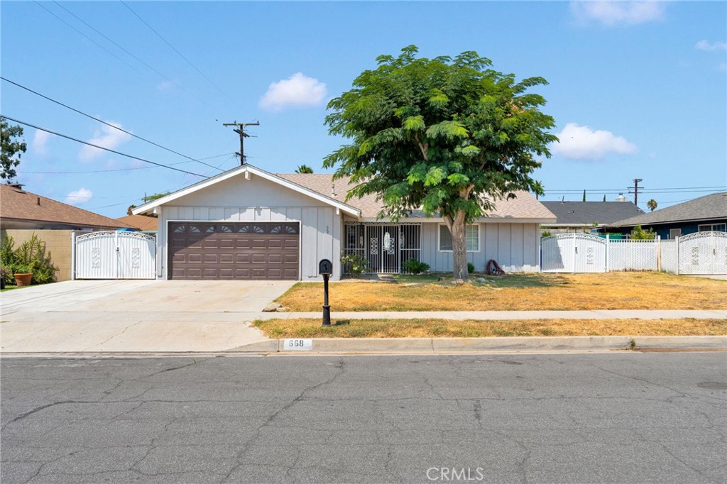 Located in the desirable city of Rialto, this spacious 4-bedroom, 2-bathroom home offers comfort, curb appeal, and security. Step through elegant double entry doors into a welcoming floor plan featuring a cozy living room with a fireplace and a large dining area with sliding glass doors leading to the backyard — perfect for indoor-outdoor entertaining!
Enjoy cooking in the updated kitchen and relaxing in the renovated bathrooms, including a master suite with a vanity area separate from the walk-in shower and restroom. Colonial-style windows give this home a sense of timeliness elegance while new carpet brings a fresh, move-in-ready feel and ample hallway storage space provides the space a family needs to make a house a home.
This home boasts a secure and inviting front porch with wrought iron security gates plus a wide driveway leading to an attached 2-car garage. Outdoor space includes a large covered patio, expansive backyard, and generous side yards that are each enclosed with wrought iron gates.
Don’t miss the opportunity to own this charming home in one of Rialto’s most sought-after neighborhoods near beloved downtown Rialto and centrally located near the 10/210/215 freeways, SBD international airport, many parks and shopping centers!