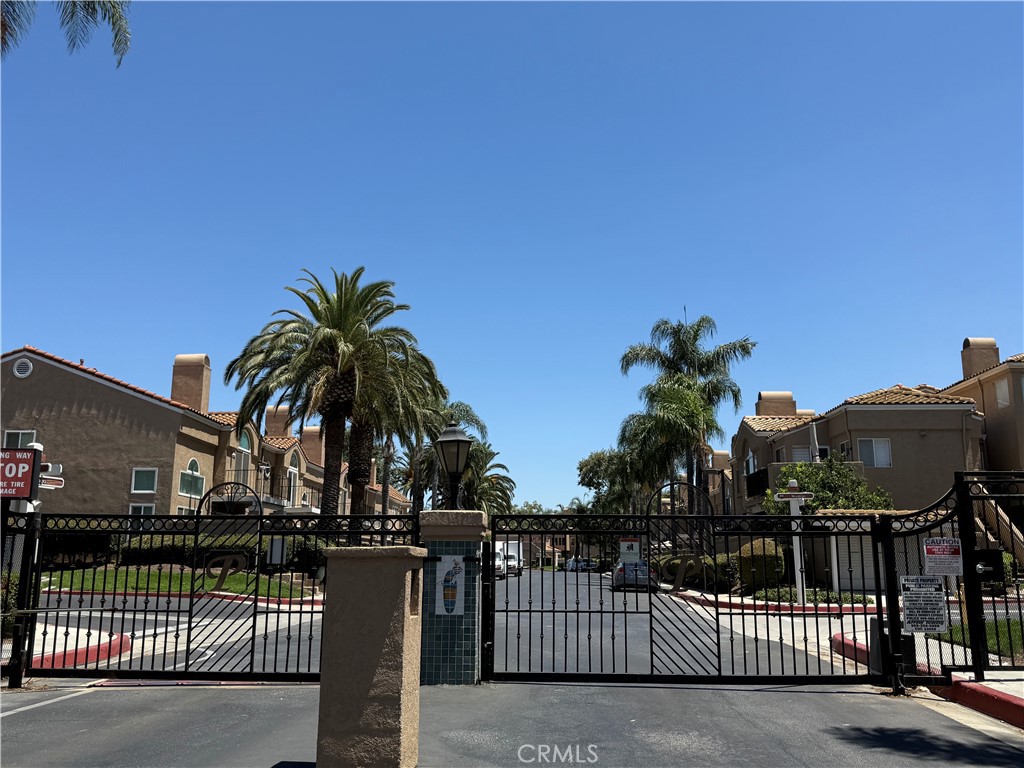 Beautiful Two-Story Townhome In The Private Gated Community Of Portofino. You'll Feel As if You're At Your Own Private Resort- Gorgeous Grounds With Short Walking Trails To, Stream Lake Tranquil Views- Unit Features: 2 Good Size Bedrooms - Vaulted Ceilings- Living Room - Bright Open With Lovely Laminate Flooring Throughout all Downstairs- Dining Room Features A Fireplace With Beautiful Deco Tile Facing- The Kitchen Has White Cabinetry - Built-In White Appliances, Stove, Dishwasher, Nice Laminate Counters- Guest Bathroom Downstairs- At Top Of The Stairwell is A Spacious Loft That Can Be Set Up As An Office Or Used As A Small Game Area For Kids-The Main Master Suite Is Carpeted And Has Excess To The Balcony-The Master Bathroom Offers A Large Dressing Area With Combo Shower/Tub-Plus Ceiling Fan- Second Bedroom Has it's Own Bathroom. Excellent Location. There's a Park Directly Across The Street From the community, within walking distance to the clubhouse, featuring picnic areas, a Pool, Spa, Sauna, and Tennis Courts. Also, Within Walking Distance To Elementary, Middle, And High School, And Conveniently Located Near freeways.