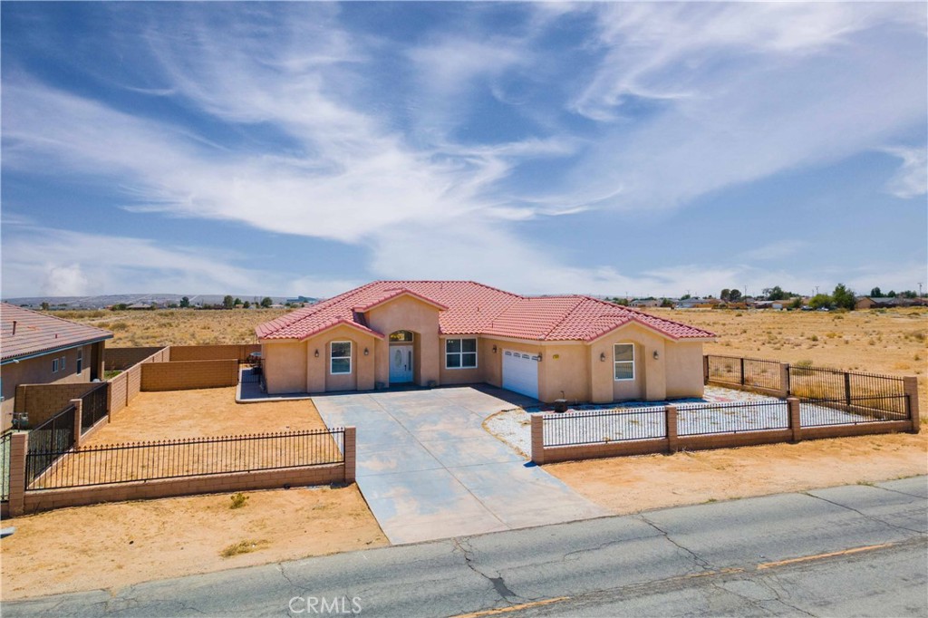 Assumable mortgage at just 3.125%—a rare chance to lock in below today's rates! Welcome to Loop Blvd. a 4-bedroom, 3-bathroom home spanning 2,567 square feet on an oversized 11,325 sq ft lot—directly across the street from Tierra Del Sol Golf Course in California City.
Step through the front door and into an open-concept layout featuring vaulted ceilings, freshly painted interiors, and tile flooring throughout the main living areas. The kitchen is framed by inviting arched hallways and includes granite countertops, recessed lighting, and dramatic vaulted ceilings.
Each bedroom is generously sized and equipped with ceiling fans. The primary suite features luxury vinyl flooring, private backyard access, and a spa-style bathroom complete with a jacuzzi tub, oversized stand-up shower, granite double vanity, and walk-in closet.
A separate laundry room adds functionality, while one of the three bathrooms offers direct access to the backyard—ideal for when having summer bbq's or entertaining out back. The property is fully fenced with a combination of block wall and wrought iron, providing both privacy and security. An attached 2-car garage is complemented by an oversized driveway with room to park at least additional vehicles—perfect for guests, toys, or work trucks. Built in 2007 and less than 30 minutes away from Edwards Air Force Base, minutes from shopping and dining, and easy access to weekend getaways in the Tehachapi Mountains or Lake Isabella. Loop Blvd offers space, security, and a financial edge few homes can match. Come check it out while its available!