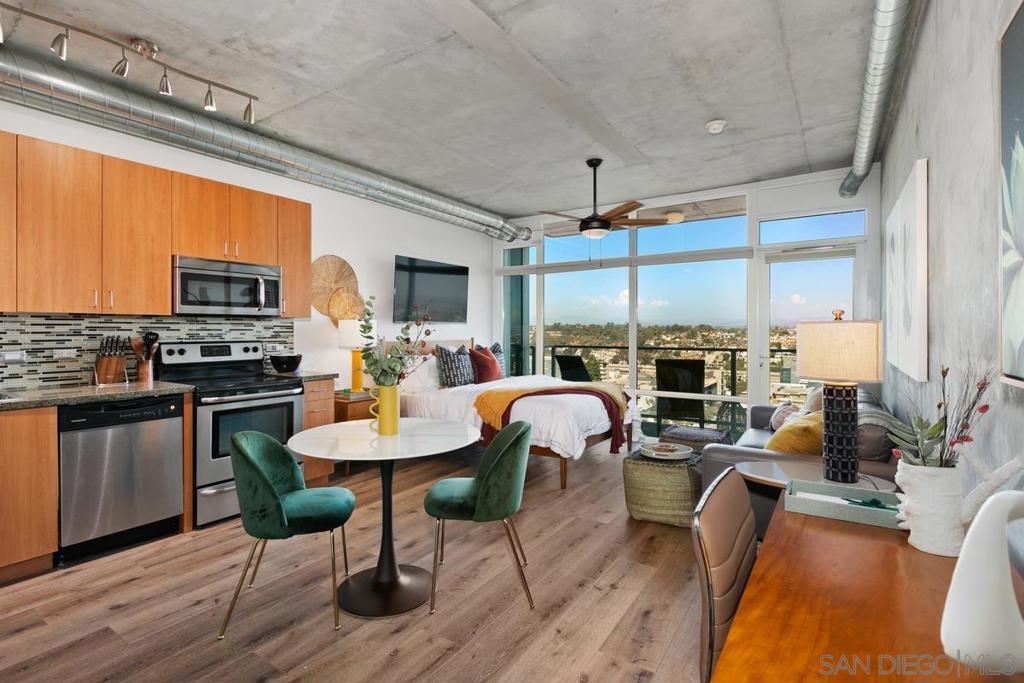 Rich jewel tones paint this trendy studio unit which features a bright and inviting living area designed with style and comfort in mind. Floor-to-ceiling windows fill the space with natural light and showcase east-facing views of the mountains, the morning sunrise, and a partial view of the Coronado Bridge. Durable vinyl floors run throughout the space, which includes a full kitchen, in-unit washer and dryer, and a private balcony where you can start your day with fresh air and morning coffee. From the balcony, enjoy peaceful skyline views and the occasional visit from hummingbirds. Furnishings are negotiable, making this an easy transition for a homeowner or a true plug-and-play opportunity for an investor. This unit is located in the Smart Corner building in Upper East Village, with quick access to some of the city’s favorite eateries and cafés (including the locally famous Hodad’s, as well as a 7-Eleven and Subway right downstairs). Building amenities include secure underground parking, a well-equipped gym, and a rooftop lounge with multiple seating areas, grilling stations, a relaxing spa, a thriving community garden, and spectacular 360-degree views of Downtown San Diego, Balboa Park, and the ocean. 3D VIRTUAL TOUR AVAILABLE Smart Corner offers the perfect blend of live, work, and play. Its central location puts you minutes from major freeways—including the 163, I-5, and Highway 94—as well as Petco Park, the Gaslamp Quarter, San Diego City College, and Balboa Park. For added convenience, the trolley stops right beneath the building, making it easy to connect anywhere in the city. Residents enjoy outstanding amenities, including a 20th-floor rooftop deck with panoramic views, a spa, barbecue stations, a wet bar, and a well-equipped fitness center on the second floor.