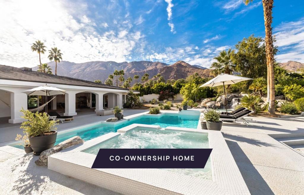 New co-ownership opportunity: Own one-eighth of this professionally managed, turnkey home. Enter this just-renovated 5-bedroom, 7-bath stucco home through a picturesque garden, the calming sounds of a limestone fountain burbling nearby. Open the steel and glass doors and you'll discover an open floor plan living space that has it all. The living room features a soaring, beamed wood ceiling and sleek gas fireplace, with an adjoining game space and a stylish bar. Hand-troweled matte concrete floors run throughout, as do wood and welded steel accents. The gourmet kitchen has top-of-the-line appliances and a massive island for food prep and casual dining. The kitchen is separated from the formal dining space by a floating glass wine wall. All the bedrooms have room for king beds and the ensuite bathrooms include walk-in showers, matte black fixtures and white quartz counters. The home also has a private office. This home comes fully furnished and professionally decorated.