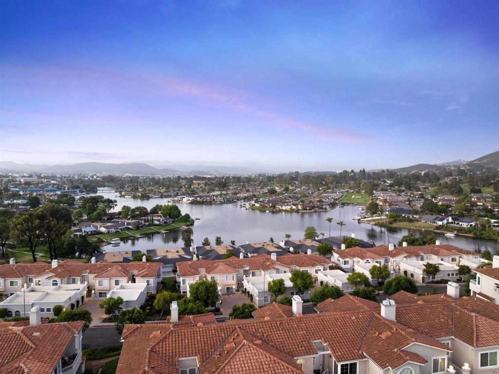 Welcome to your everyday getaway in the coveted Panorama community at Lake San Marcos! This 2-bedroom, 2-bath condo offers breathtaking views of the lake and mountains—enjoyed right from your kitchen, dining area, living room, primary suite, and expansive private patio. Unwind by the cozy fireplace as you watch the water views. The home includes in-unit laundry, a detached garage, and an ideal layout for entertaining and privacy from the bedrooms. Just a short stroll to the Lakehouse Resort, golf course, Sail Club, and community pool, this home gives you access to all the amenities that make Lake San Marcos a true lifestyle destination. Everyday will feel like you are on a vacation!