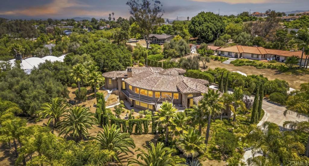 Welcome home to 114 Rancho Camino! This elegant estate is nestled in the heart of Fallbrook on a beautifully landscaped 1 acre corner lot. The expansive 4-bedroom, 4 full bathrooms with 2 additional half baths offers 3,450 sq. ft. of refined living space that lives like a single story home. The property is a perfect blend of timeless charm with modern comforts for your most discerning buyers. The chef's kitchen features ample cabinet and counter space with a built in refrigerator, Jenn Air stove top and plenty of space to make your favorite meal. Unwind and relax after a long day in the resort like primary suite featuring plenty of space with a thoughtfully designed layout with an jacuzzi tub, oversize walk in shower and custom closet. Walk down stairs to the basement area perfect for a family room, game room or possible additional family living space. The seamless flow to the outdoor living space is perfect for entertaining or relaxing in private tranquility with peaceful views, mature landscaping, and ample room for a pool, garden, or guest house. A rare opportunity to own a slice of country living with easy access to freeways, shopping, dining, schools and beaches. 114 Rancho Camino is not to be missed!