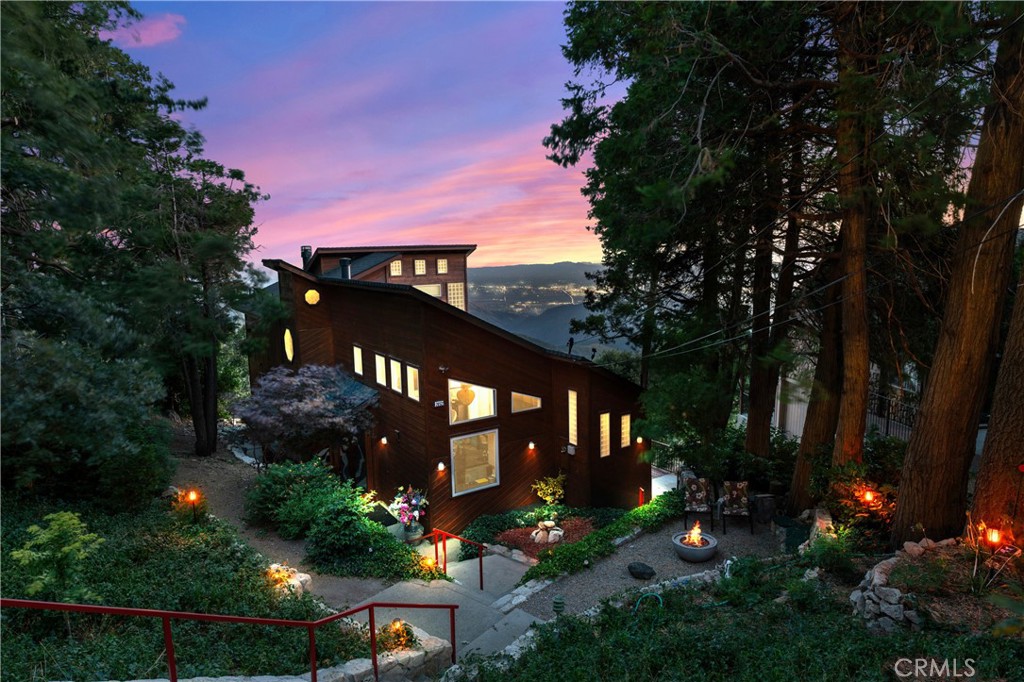 This Amazing Lake Arrowhead property has more "Glitz and Glamour" than a NY City high rise. More "Peace and Beauty" than ocean front living in Laguna Beach. Is more "Otherworldly" than the canals and treasures of Venice/Italy. And,, it boasts "Epic Views" of forests, mountain ridgelines, city lights (100+ miles), the Pacific Ocean and Catalina Island from its floor-to-ceiling "Windows and Walls of Glass." If this isn't enough to take your breath away - how about this? The home is an architectural masterpiece that has two (2) designer curated master suites, 3 fireplaces, 3 spa-inspired bathrooms, concrete crackle floors and counter tops, soaring 22 -foot ceilings, 8 skylights, a chef's kitchen, mudroom, separate laundry room, an indoor jacuzzi tub, shower with steam, custom built concert hall sound system, approximately 800 sq. ft. of "additional" buildable space, and a 2 car garage with parking for 4 guest cars. This property not only offers you a Magical and Abundant lifestyle that promotes "Joy, Creativity, and Inspiration" but, for a limited time only, it is also offering you **** 5% Fully Amortized Financing ****