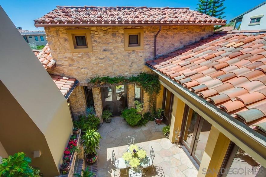 Welcome to elegant living in Avaron Del Sur. This stunning classic home features high quality construction and finishes throughout. Interior highlights include a chef's kitchen, center island with prep sink, stainless steel appliances, granite counters, butlers pantry, walk-in pantry & ample storage cabinetry. Built-in side-by-side refrigerator, double ovens, professional 6-burner gas stove.  Light filled living/dining room with fireplace and  french doors opening to striking courtyard patio, with fireplace.  A first floor master bedroom suite, featuring dual vanities, make-up vanity, large soaking tub and separate shower. A private first floor en-suite for guests. including full bath. Large first levelhome office, with adjacent 1/2 bath. Family room centers around large built-in media cabinet, stone fireplace and surround sound. The Tuscan architecture, with Tumbled Travertine flooring in the Versaille pattern add to the warm and bright feel of this home. Situated on a.26 acre lot the 4 Bed / 1 optional and 4-1/2  Ba. almost 4,000 sq ft. home offers spacious comfort living.  Main floor laundry room with deep laundry sink and ample storage. Backyard is perfect for a beautiful private outdoor gathering space, featuing a lush, quiet  manicured  garden environment. Separate one and two car  epoxy fooring garages and full home water purification system and Solar. Avaron residents enjoy access to all 14 community parks in Del Sur—11 of which feature pools—creating an unparalleled lifestyle centered around family, recreation, and community. Nearby Crosby Club with award winning golf course and amenities. Gated community, top ranked schools and shopping
