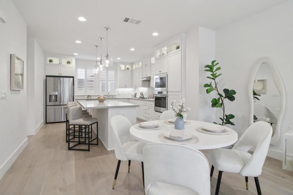 Elegance meets convenience in this privately gated 3-bedroom, 3.5-bath townhome bathed in natural light, perfectly positioned between the vibrant downtowns of Redwood City and San Carlos. The open-concept main living and chefs kitchen floor showcases rich engineered hardwood floors, granite countertops, and access to a private deck. Upstairs, the luxurious primary suite features a walk-in closet, a spacious shower with built-in bench, and an upgraded bidet toilet. The lower floor offers a versatile bedroom and full bath, ideal for guests, a home office, or a hobby room. Completing this sophisticated residence is an attached 2-car garage with a Tesla EV charger. Built in 2019, this home offers walkable access to gourmet markets, charming cafés, parks, and the San Carlos Farmers Market, with effortless commutes via US-101 and scenic bike routes.