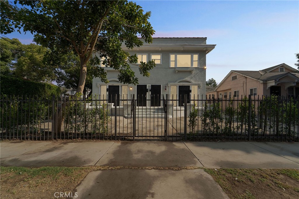 Exceptional 4-unit multifamily investment on a prominent corner lot in the heart of Los Angeles, directly across from Menlo Avenue Elementary School. The property features a brand-new roof (2025) and two meticulously remodelled and vacant 3-bedroom/2-bath units with all updated electrical and plumbing, ideal for immediate lease-up or owner occupancy. Two additional (and also remodelled) 3-bedroom/1.5-bath units are tenant-occupied near market rent, with RUBS provisions in place to pass through ALL utility costs. The 4,176 sq ft building sits on a 6,450 sq ft lot and offers over eight off-street parking spaces. Recent upgrades, including plumbing and electrical upgrades, the new roof and completed termite clearance, make this a TURNKEY asset. Located minutes from BMO Stadium, Exposition Park, the LA Coliseum, USC, public transportation, shops, and restaurants, this property combines strong current income with clear rental upside in a high-demand Los Angeles location.