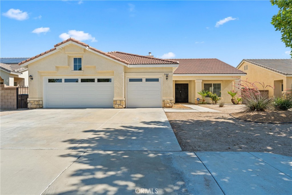 Beautifully Maintained Single-Story Home in Prime West Lancaster neighborhood, conveniently located near shopping, restaurants, and freeway access. The open floor plan includes a family room with a cozy fireplace, formal living and dining areas, updated kitchen with brand-new smart appliances, tile roof, block wall fencing, and low-maintenance, drought-tolerant landscaping in both the front and backyard enjoy outdoor living under the covered patio and take full advantage of the spacious 3-car garage.