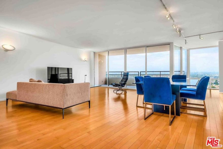 Stunning urban resort condo at Marina City Club in Marina del Rey! Upon entering, you are greeted with spectacular city, hill, and distant mountain views, abundant natural light, and an airy ocean breeze. This beautiful three-bedroom, two-bath home was remodeled by renowned minimalist architect Ted Tokio Tanaka, FAIA. His elegant design features an open-concept floor plan that maximizes the panoramic city views, complemented by crisp white walls and maple wood flooring throughout. A freshly painted, expansive living room with access to a large balcony is ideal for relaxation and entertaining. The kitchen includes ample cabinetry, Bosch dishwasher and refrigerator, LG built-in microwave, and GE oven/range. The primary bedroom, overlooking Oxford Basin, offers a remodeled bathroom with glass windows to enjoy the views. Both bathrooms feature custom sinks and vanities, each with a heated INAX washlet seat and bidet. This desirable end unit is situated on the 10th floor, which is effectively the 15th floor due to the four-level parking structure beneath, in the Center Tower with direct access to the Fitness Center and Restaurant. Two side-by-side parking spaces are conveniently located on the street level near the elevator. Marina City Club offers resort-style living with 24-hour security, a Fitness Club with sauna, jacuzzi, and steam room, three pools, six tennis courts, racquetball and paddle tennis courts. On-site amenities also include a fine dining restaurant, room service, beauty salon, dry cleaning, and car wash services. Just moments away from Marina del Rey's Mother's Beach, the famous Abbot Kinney, Venice Canals, and an array of restaurants and shops. Conveniently close to the 90 and 405 freeways, and less than 30 minutes from LAX International Airport. Your dream Marina lifestyle awaits!