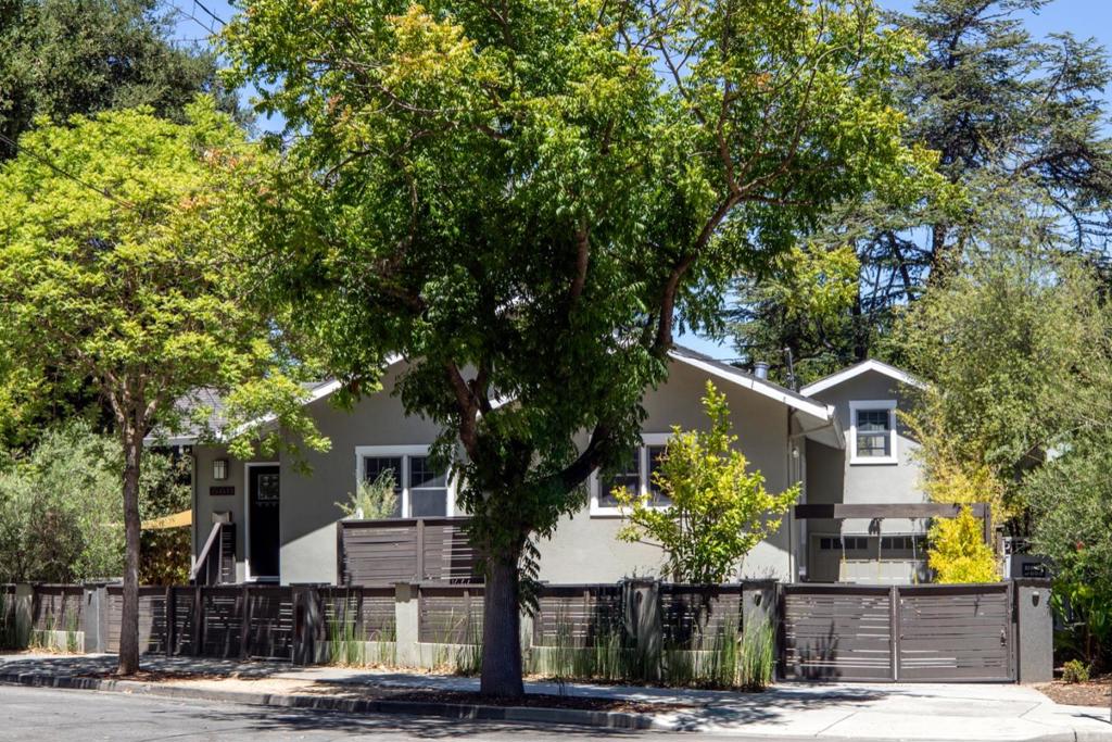 Located just blocks to downtown Palo Alto this home offers an open floor plan with vaulted ceilings, multiple windows plus finished basement with separate outdoor entry for optionality. The impressive great room is the central gathering place with gas fireplace, hardwood floors and dining area. Adjacent kitchen includes granite counter tops, tumbled stone back splash with stainless steel appliances including LG refrigerator, Bosh dishwasher, gas Elan range and oven. The primary bedroom includes en suite bath with dual vanity, jetted tub, stall shower with glass enclosure and walk in closet. Additional office with vaulted ceiling is a bonus off of the primary bedroom. Two additional bedrooms share a hallway bath with a tub/shower combination. The basement has a separate outdoor entry and includes two bedrooms, one and a half bathrooms and full kitchen with stainless steel Samsung gas range, LG refrigerator and LG washer/dryer. The wrap around backyard includes a fire pit for evening relaxing, raised planter beds and olive trees. Excellent Palo Alto schools and incredible opportunity and optionality with the completely separate and self contained basement. Outstanding location with close proximity to Cal Train, downtown Palo Alto and Menlo Park, HWY 101 and Stanford University.