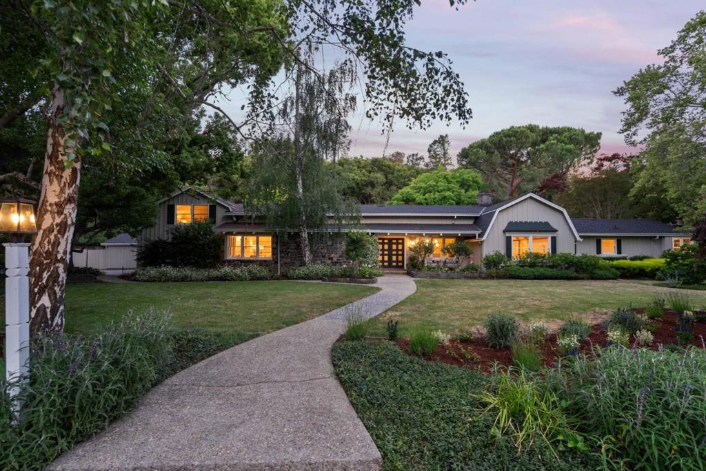 Located in the desirable Pink Horse Ranch area, this classic and timeless home offers one acre of tranquility with extra wide frontage and a picturesque backdrop of mature trees. The home features original Dutch Colonial architecture, freshly updated with all new paint inside, refinished hardwood floors throughout the main level, and new carpet upstairs. Reclaimed cobblestones from San Francisco adorn the front of the home and the living room, a special touch by developer, Wendell Roscoe. The main living areas are open and flowing off the centrally located kitchen, offering plenty of room for entertaining. A private wing on the main level comprises three bedrooms, including the primary suite and two bedrooms each with outside access. At the opposite end of the home, a secluded upstairs wing includes two bedrooms and a bath with flexibility for a variety of lifestyle needs. Stepping outside, the backyard oasis features a sparkling pool, charming gazebo, pool house with half-bath, plus a soccer-worthy lawn for recreation. Located within the excellent Los Altos school district and just minutes from the Village, this home combines convenience with serene country living plus the opportunity for further transformation, making it truly an exceptional property.