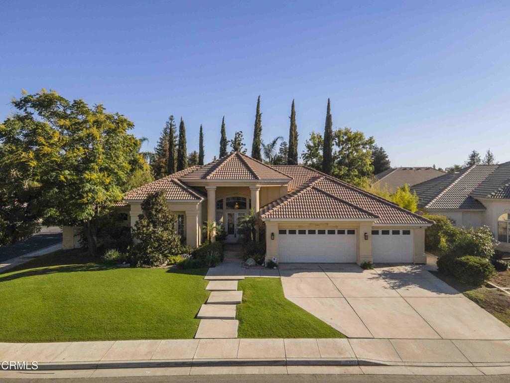 Stunning single-story residence with timeless curb appeal, set on a spacious lot with mature trees & landscaping. Inside, the unique layout offers 3 separate wings, showcasing a formal living room, dining area & a welcoming family room with fireplace and views of the backyard. The gourmet kitchen is designed for entertaining, featuring granite counters, stainless steel appliances, double ovens, gas cooktop & a large island with seating. 5 well-sized bedrooms include a serene primary suite with spa-inspired bath, dual vanities, soaking tub, walk-in shower & generous closet space. Additional highlights include updated bathrooms with custom tile, indoor laundry & abundant storage throughout. Step outside to your private backyard oasis with sparkling pool, covered patio & multiple lounge areas surrounded by greenery. This backyard is thoughtfully crafted as a private retreat, blending beauty with functionality. A spacious deck serves as the central gathering space, ideal for outdoor dining & relaxation. A 3-car garage & extended driveway provide ample parking. Located in a desirable neighborhood, this home blends quality craftsmanship with everyday comfort and style.