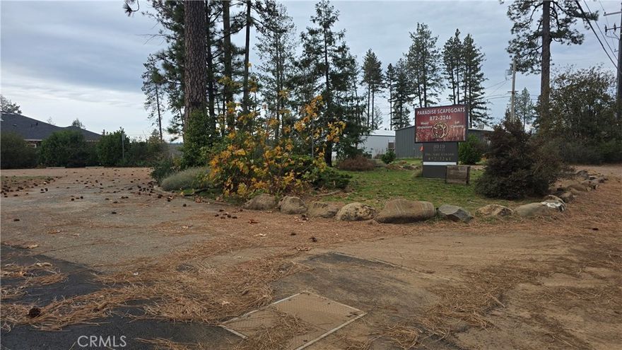 PRIME LOCATION for this .99-ACRE COMMERCIAL LOT in Paradise! New Septic System (tank & leach field) installed in 2014, then re-inspected and passed in April of 2023. The Paradise Irrigation District water connection fee has been maintained and is ready for you to reconnect without the high cost of a new connection. Both of these are big money savers for the new owner!! Discover endless possibilities with this .99-acre parcel zoned C.C. (Community Commercial) in the heart of Paradise! Previously home to a well-established local veterinarian’s office since 2013, this property offers a prime location, excellent visibility, and incredible flexibility for future development. This property offers 117 feet of Skyway frontage on the main highway, providing exceptional traffic exposure and visibility for your business. The 2,478 sq. ft. building was lost in the Camp Fire, but much of the infrastructure remains intact, including lovely mature landscaping, numerous trees, and a well-maintained circle asphalt driveway and parking lot still in good condition. Zoned Community Commercial (C.C.), the lot allows for a wide range of potential uses—such as retail, offices, restaurants, service businesses, storage, hotels or motels, and even multi-family residential housing (with Town approval).  According to the Town of Paradise, the Community Commercial zone accommodates a full spectrum of locally and regionally oriented commercial land uses.  Depending on constraints and approvals by the Town of Paradise, residential densities may reach up to 10 dwelling units per acre.  Enjoy beautiful canyon views to the back of the property and stunning Sawmill Peak mountain range views to the front. There’s also a small driveway providing access to two additional terraced areas located behind the former main parking lot and business site—ideal for additional structures, storage, or expanded parking.  For complete zoning definitions and permitted uses (identified as “P,” “C,” “S,” or “A” depending on approval type), please visit the Town of Paradise zoning information page: WWW.TOWNOFPARADISEMAPPING.COM   This is your opportunity to bring new life to a fantastic commercial property in a thriving, rebuilding community — imagine the possibilities!