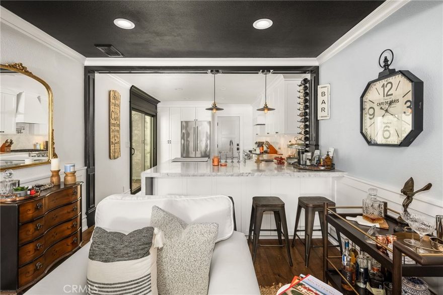 Experience luxury living in this stunningly remodeled condo offering a perfect blend of style, comfort, and functionality. The upgraded chef’s kitchen features soft-close cabinetry, Carrara Bianca Suprema marble counters with a waterfall edge, eat-on bar, new stainless-steel appliances, and a farmhouse sink — ideal for cooking and entertaining.



Enjoy European oak engineered hardwood floors throughout, complemented by custom white oak ceiling beams, a walnut built-in desk, and solid core doors that enhance both beauty and sound insulation.



Both bathrooms have been thoughtfully updated with marble floors, new fixtures, and designer finishes. Every detail shines — from the custom molding and paneling to closet organizers in each bedroom and LED recessed lighting in every room.



Comfort is effortless with a brand-new HVAC system (A/C and furnace) and new water heater providing modern efficiency and peace of mind.



Move-in ready and ideally located in the heart of Tustin, this exceptional home offers sophistication, comfort, and convenience all in one.