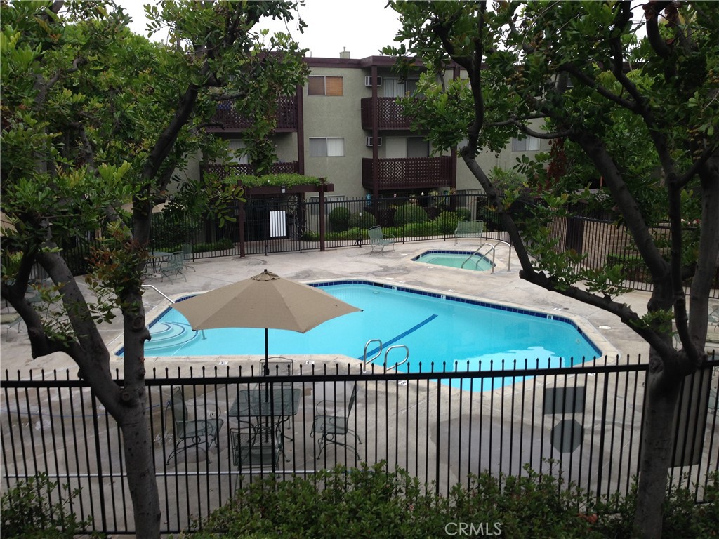 This welcoming two-bedroom, two-bath condo is located in the desirable Arroyo Seco Village community of Highland Park, one of Northeast L.A.’s most vibrant neighborhoods. The home features a comfortable open-concept living and dining area with sliding glass doors that bring in soft natural light and lead to a private balcony. The kitchen offers generous cabinet storage and an efficient layout that flows easily into the living space, while both bedrooms are well-sized with ample closets and neutral finishes. Enjoy the convenience of in-unit washer and dryer hookups, gated parking, and elevator access. The gated complex offers resort-style amenities including a pool, spa, BBQ areas, and mature landscaping that creates a peaceful setting. Perfectly positioned near the shops, cafés, and nightlife of Figueroa Street and York Boulevard, this condo combines neighborhood character, community amenities, and strong transit access. With consistent housing demand, it’s equally appealing as a personal home or an investment opportunity.