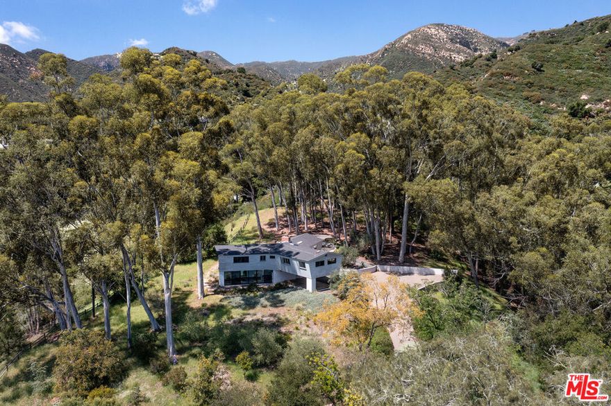 In Montecito, where ocean and mountain views create a backdrop of rare beauty, lies a property unlike any other. Set on 5.27 acres across two legal parcels, this offering is more than a home. It is a chance to create the next chapter of something extraordinary. Designed by the renowned Kem Weber, the mid-century residence radiates timeless character. Tongue and groove vaulted ceilings, cork flooring, and iconic walls of glass capture the light and landscape, creating a home that feels both rooted in design history and alive with possibility. A generous terrace opens into nature, where oaks and open sky frame sweeping views of the Pacific. The true allure of this property lies in the land itself. With two buildable parcels, the possibilities are as expansive as the views.The existing home could become a private guest retreat while a new vision rises beside it. A compound of multiple residences could take shape, united by gardens and terraces. Or the property could remain just as it is, an inspiring blend of privacy, beauty, and potential. This is not only a home but a canvas for the future. Live comfortably today, dream boldly for tomorrow, and embrace one of Montecito's rarest opportunities. Here you hold two lots and the promise of one extraordinary future.